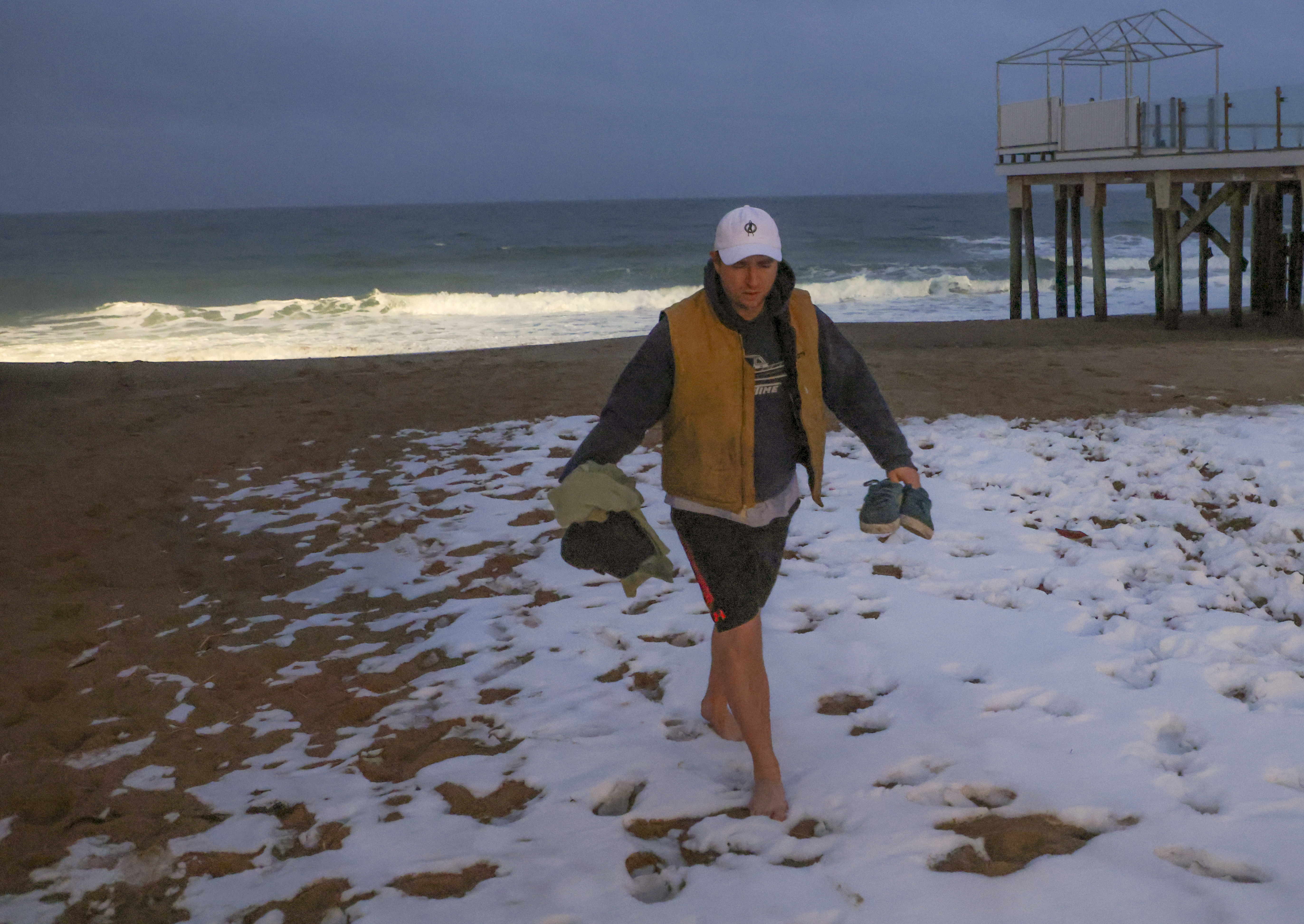 Connor Mulholland walked through the snow after his daily plunge into the ocean.