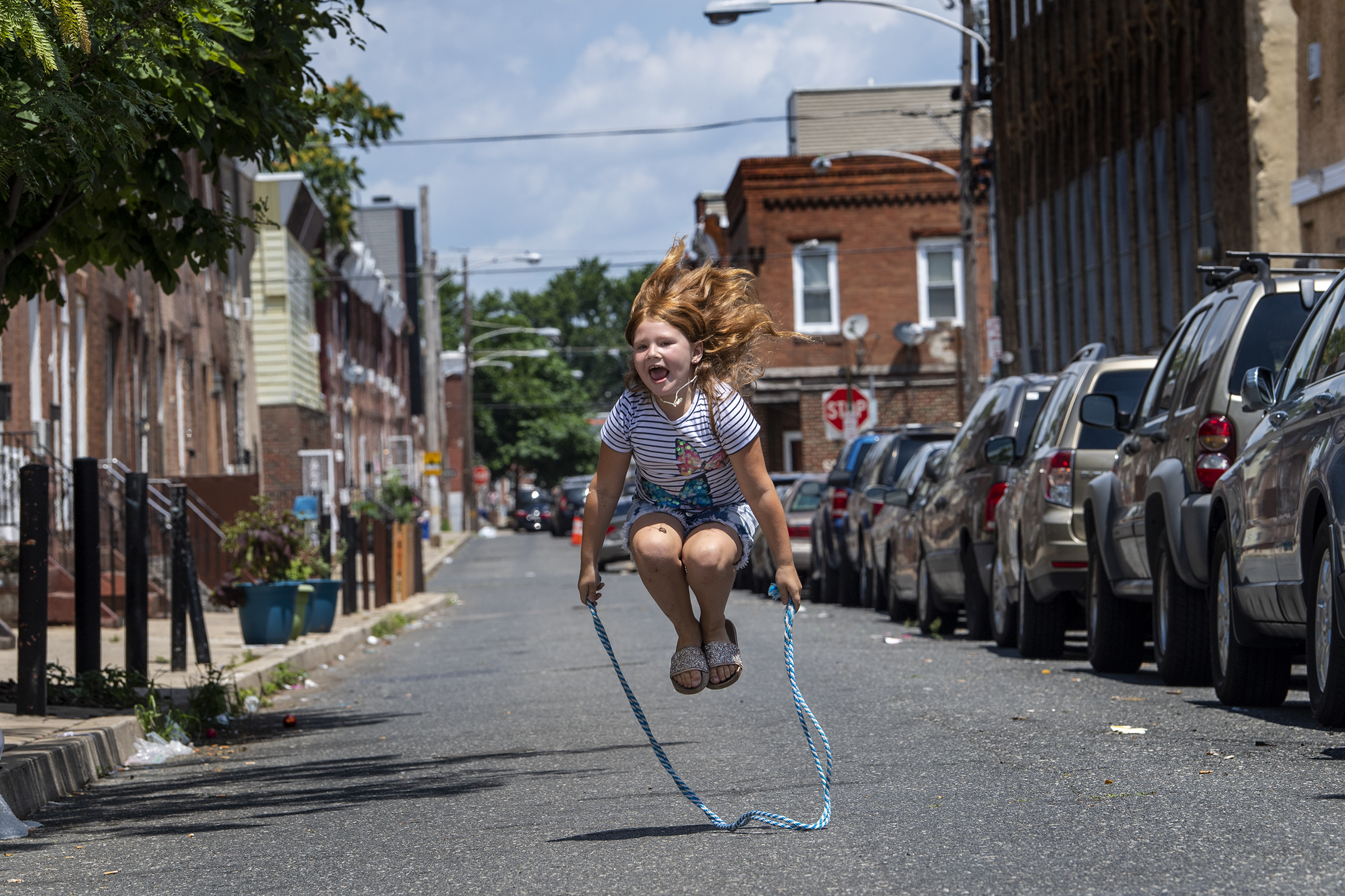 Julienna Putnick, 7, jumps rope in the middle of the street on the 2500 block of S. Marshall Street in South Philadelphia, July 15, 2020. The street was closed to traffic as part of the Playstreets program in Philadelphia.