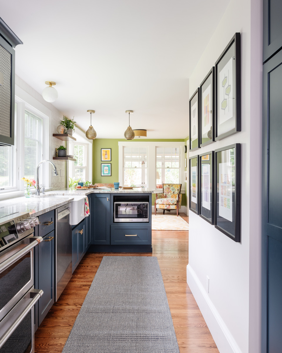 Colorful artwork by Dorrie Rifkin hangs in the sitting room where the family plays board games and Camille enjoys morning coffee.