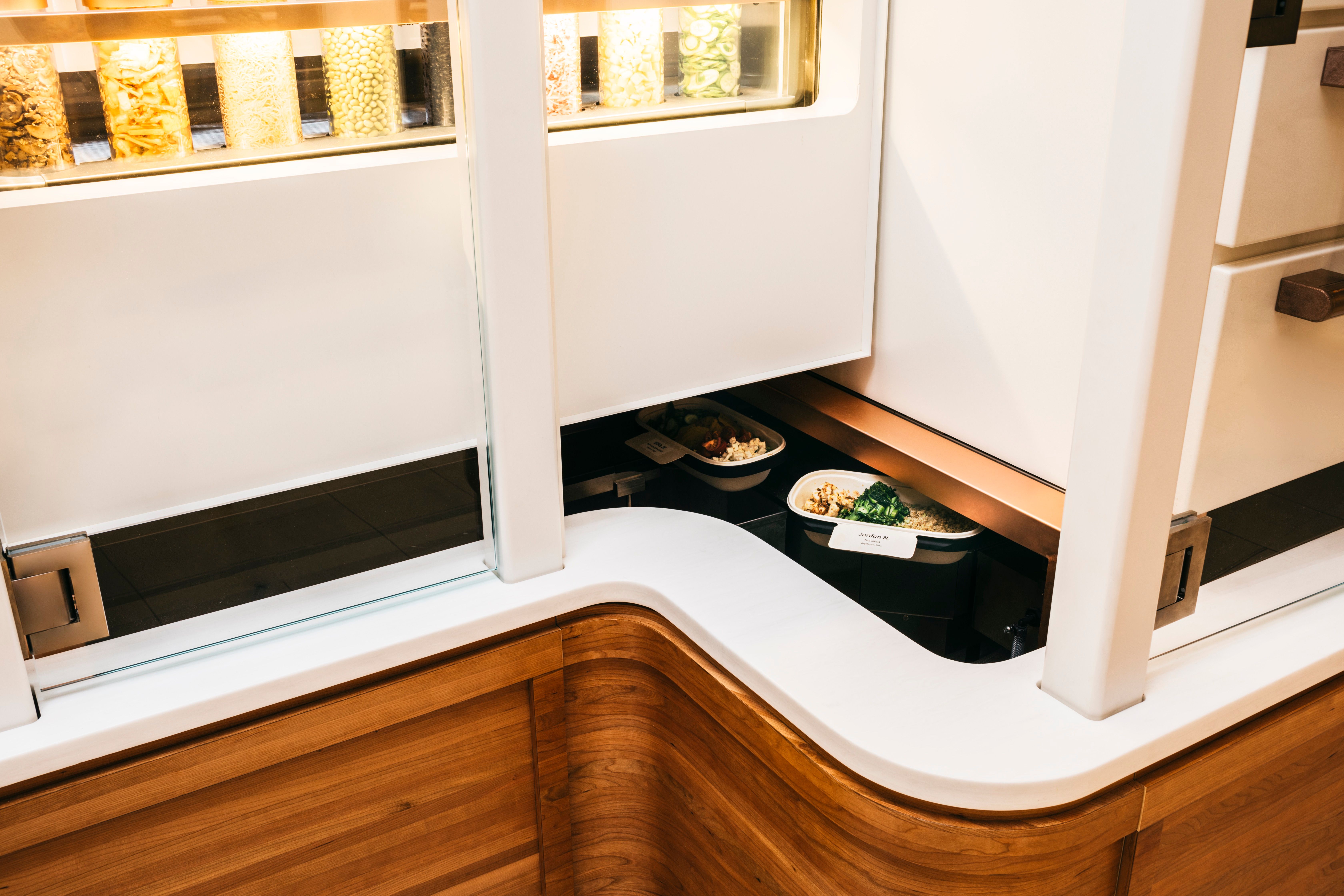 Bowls travel through the Spyce kitchen on a conveyor belt.