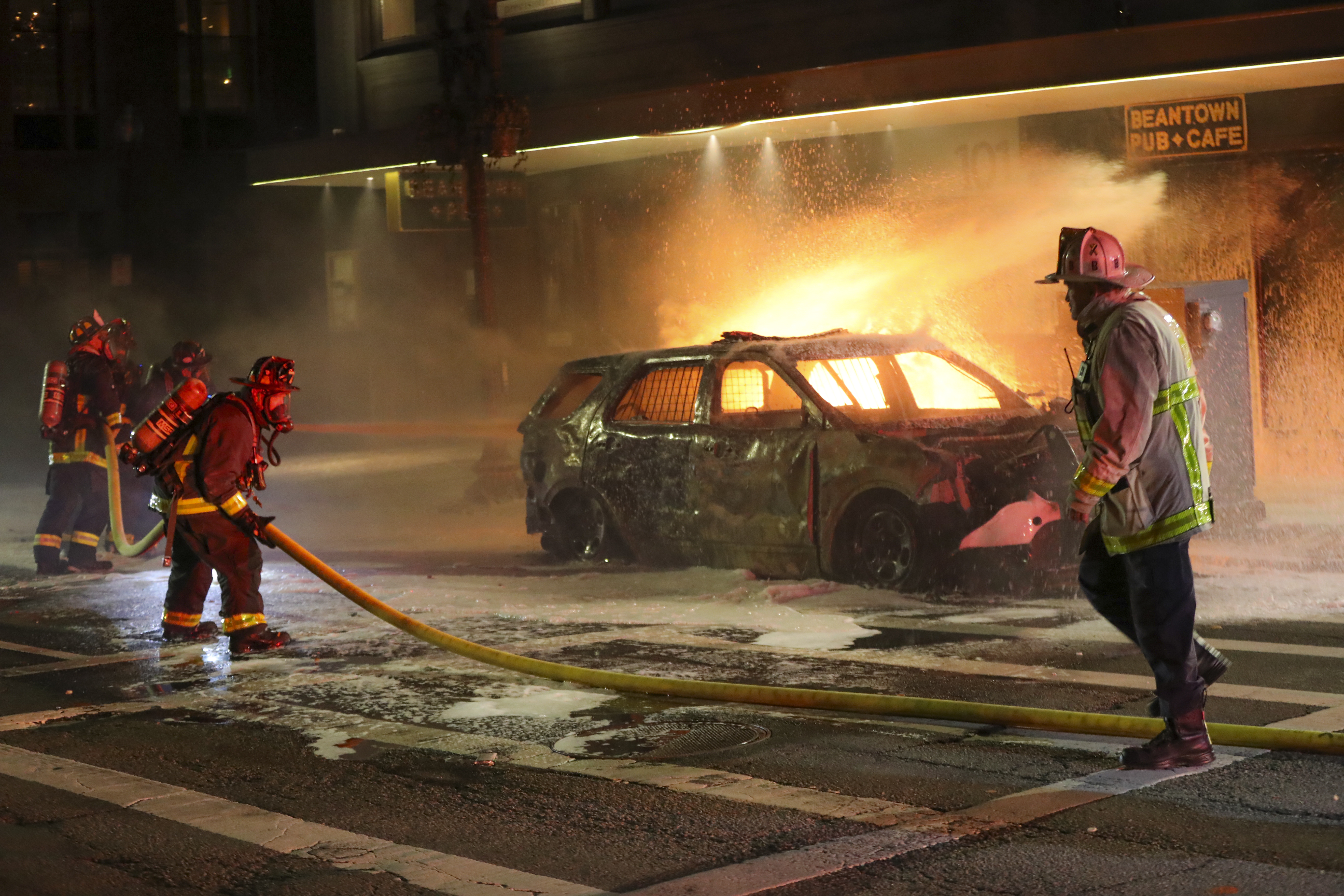 Boston firefighters put out a fire in a Boston police car on Tremont Street.