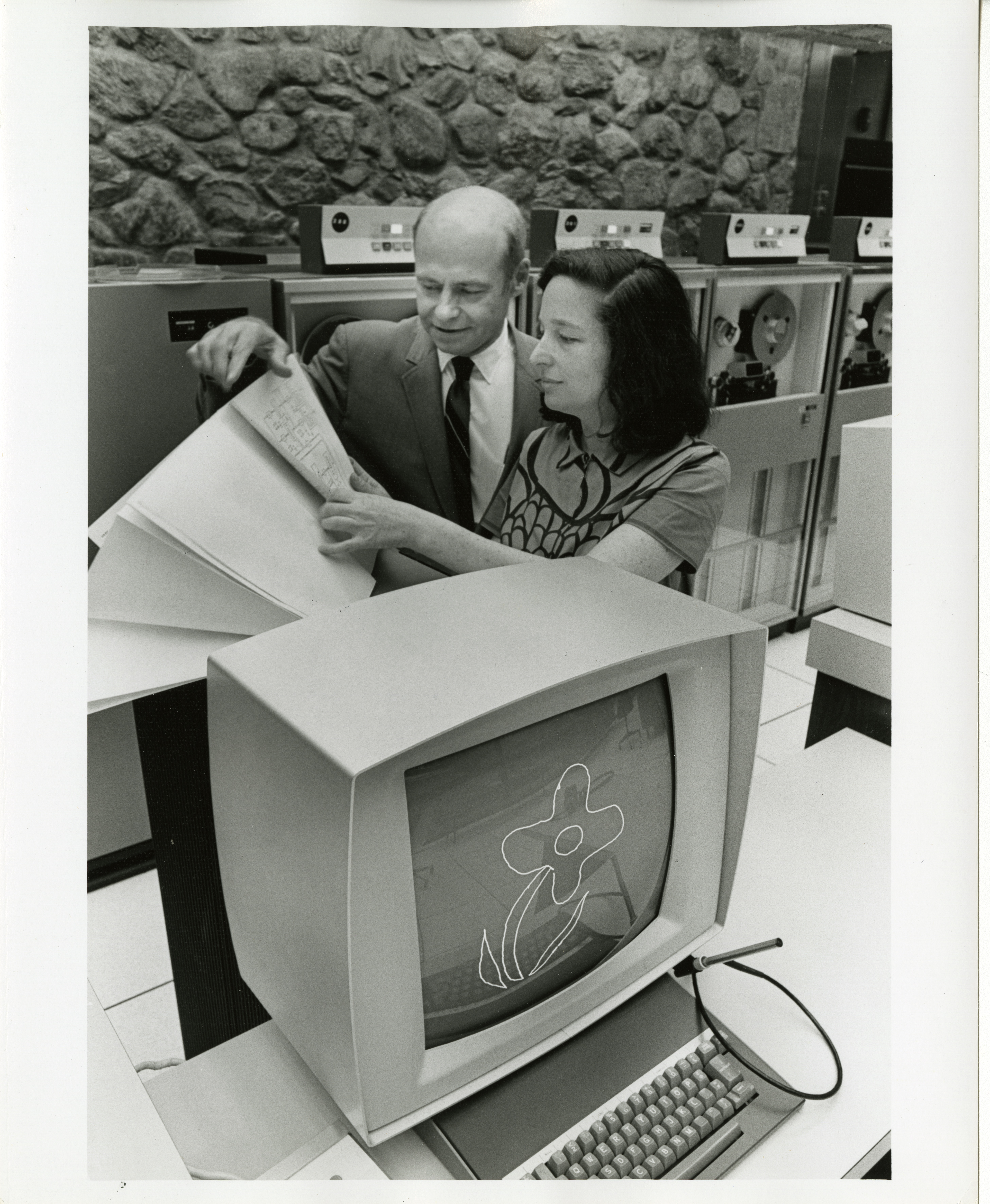Janice Lourie and patent attorney Charles Boberg at IBM in 1970. Below them is a monitor displaying a pattern she created with her software.