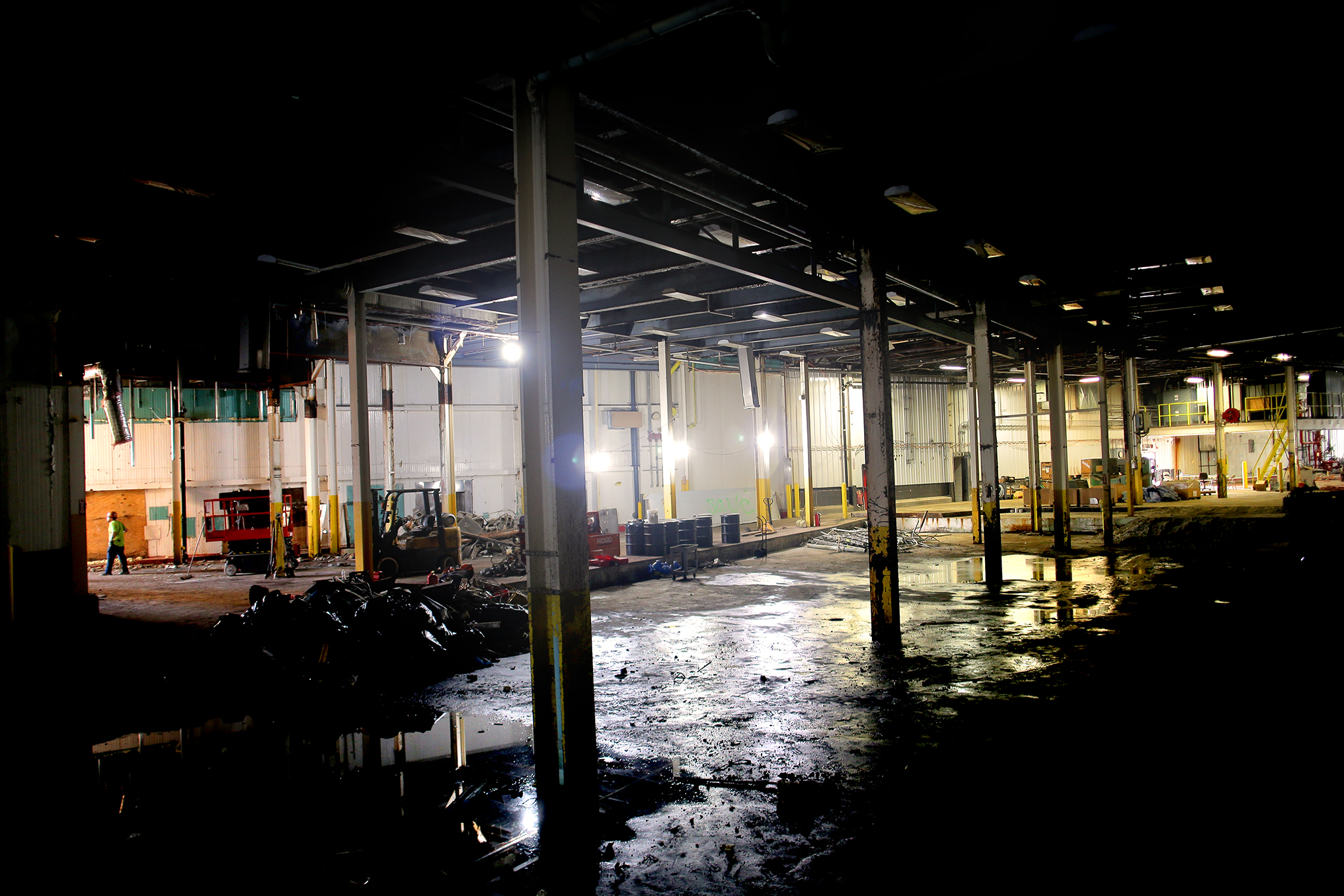 Inside the former Garelick Farms Dairy plant on the Lynnway, workers prepared to remove large storage tanks from the site so it can be redeveloped for industrial use.