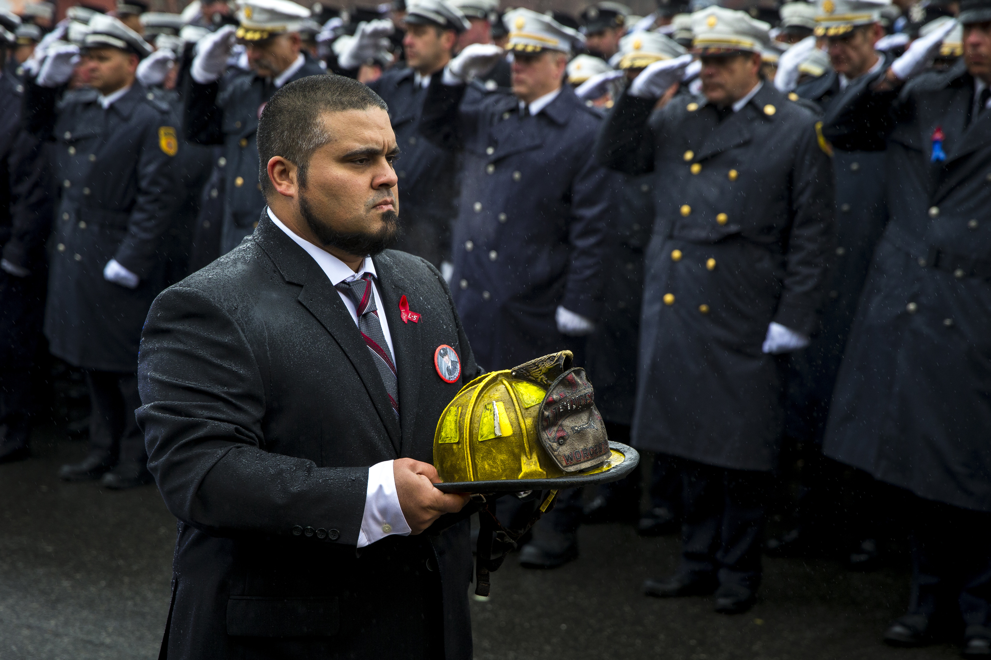 The helmet of Worcester fire Lieutenant Jason Menard was carried during his funeral procession at St. John’s Catholic Church in Worcester.