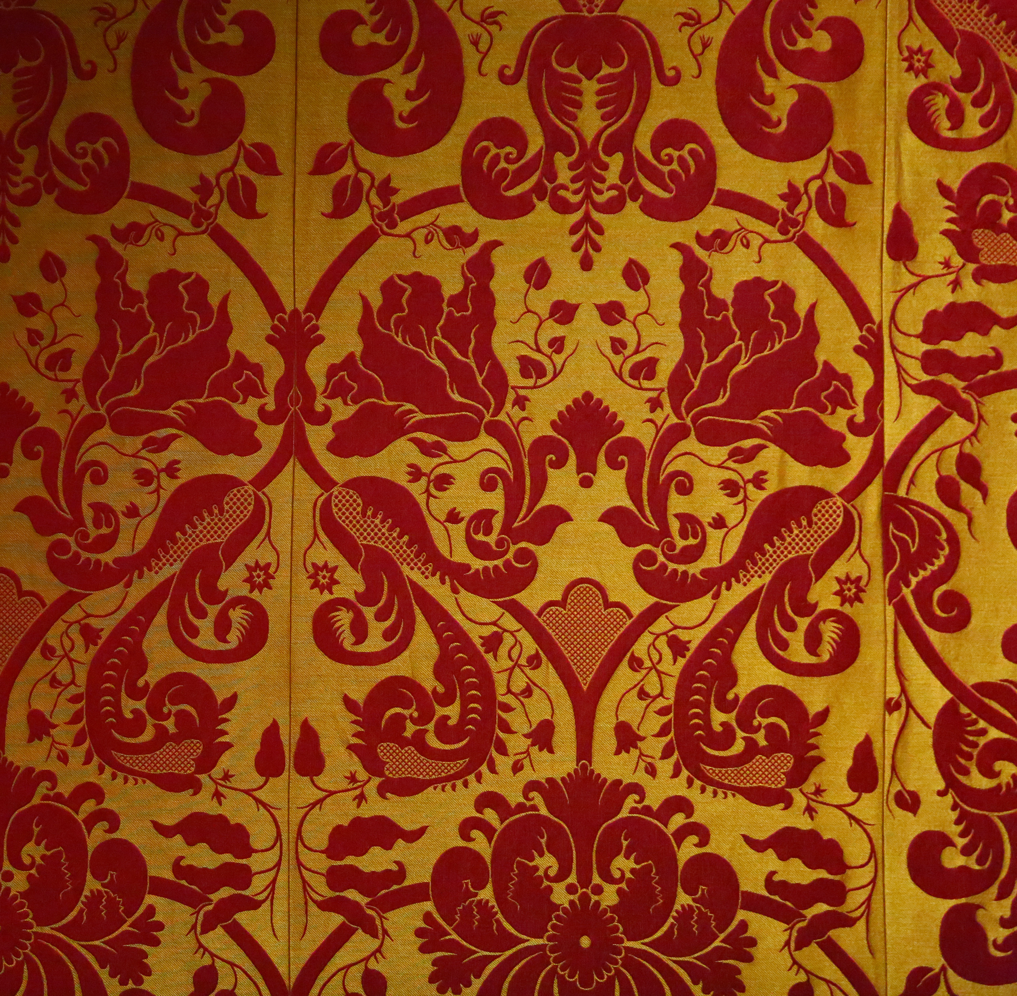 A textile with a tulip pattern is shown on the wall. During the renovation of the Titian Room in the Isabella Stewart Gardner Museum, particular attention has been given to the silk wall fabrics.