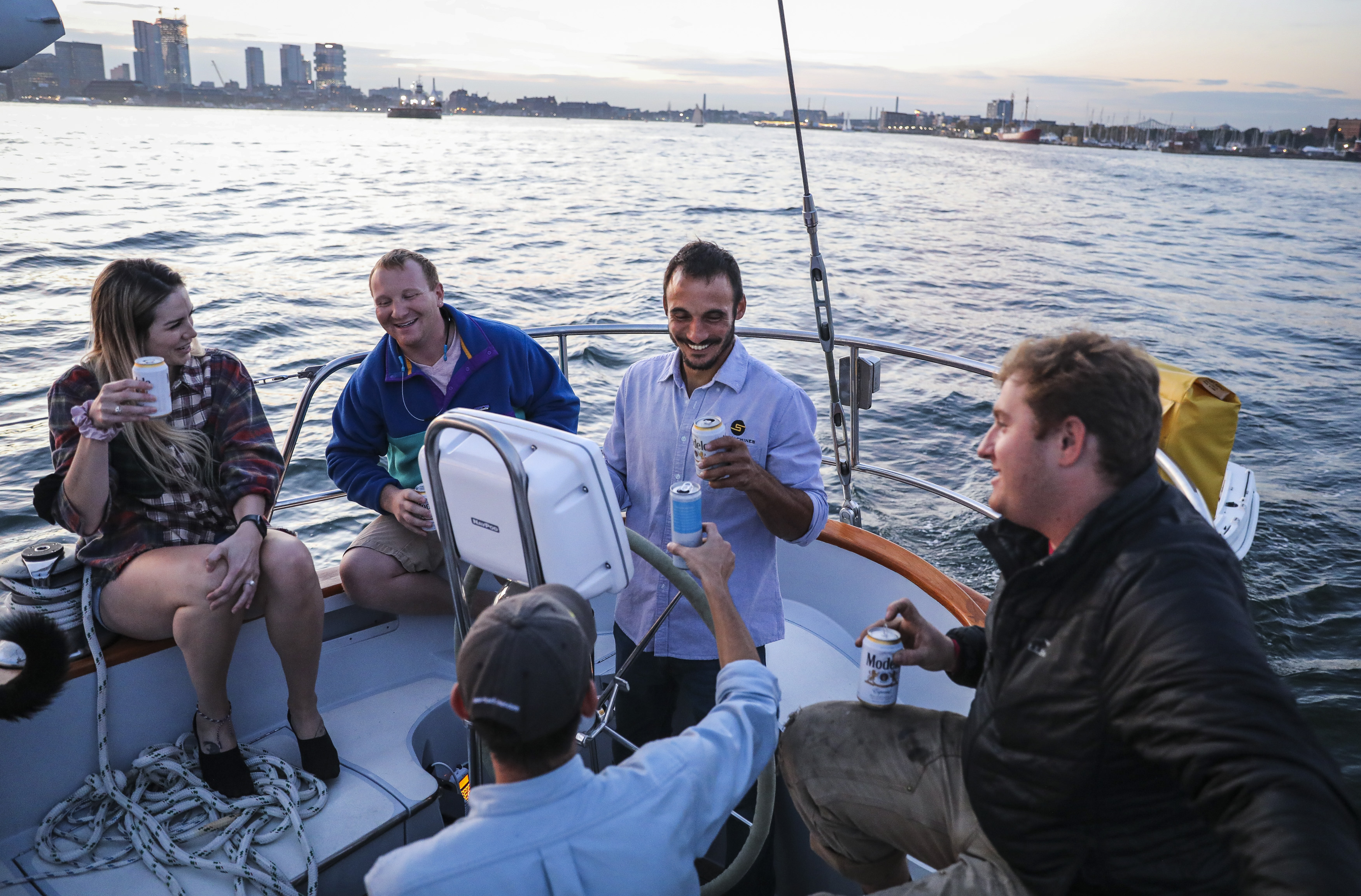 Friends and family toasted with Galdo (center) as they sailed across Boston’s harbor.