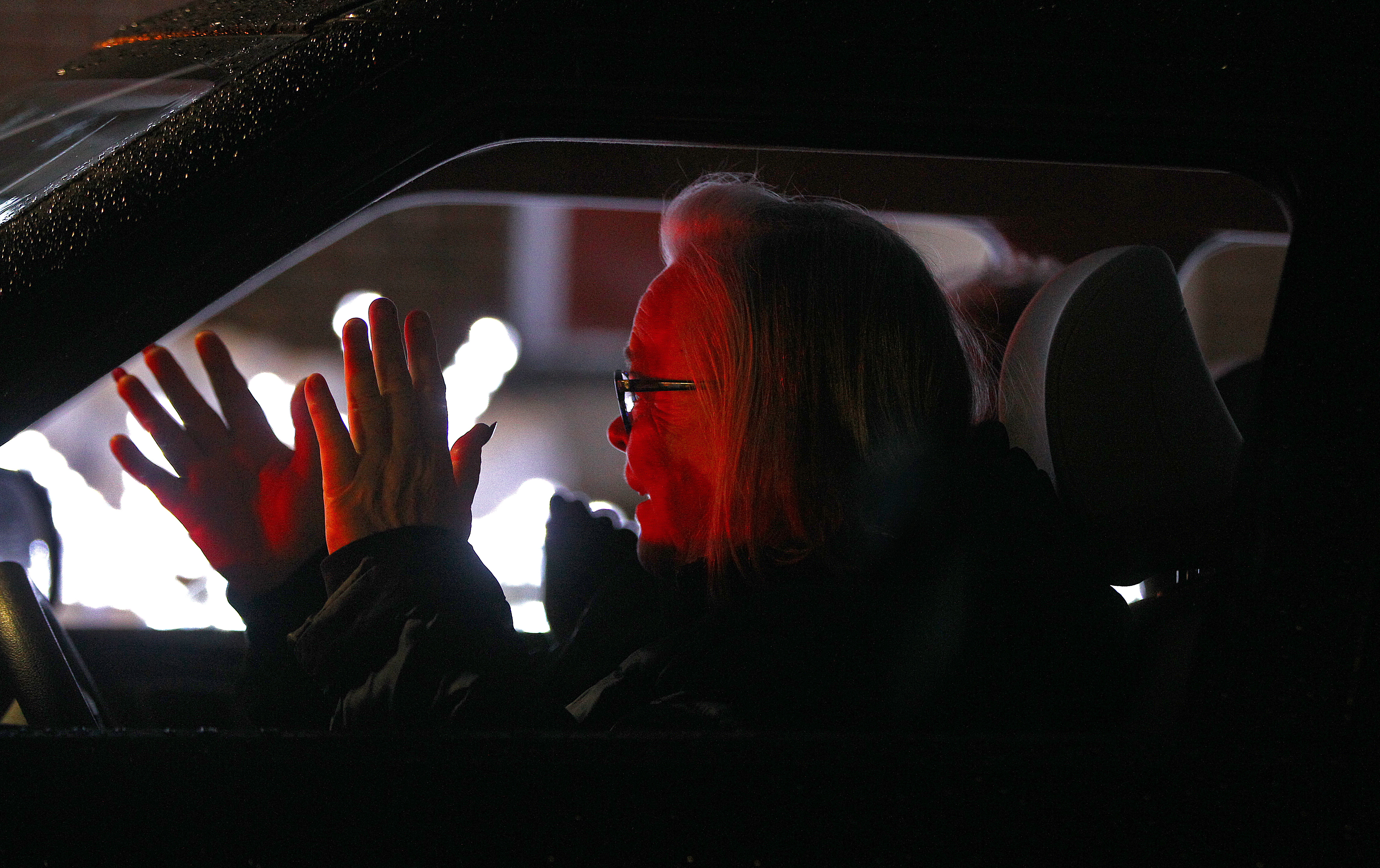Driver Eileen Kelly, and her passenger, waved at the costumed characters near the vehicles during the Winter Wonderland drive-thru around Wehner Park in Everett.