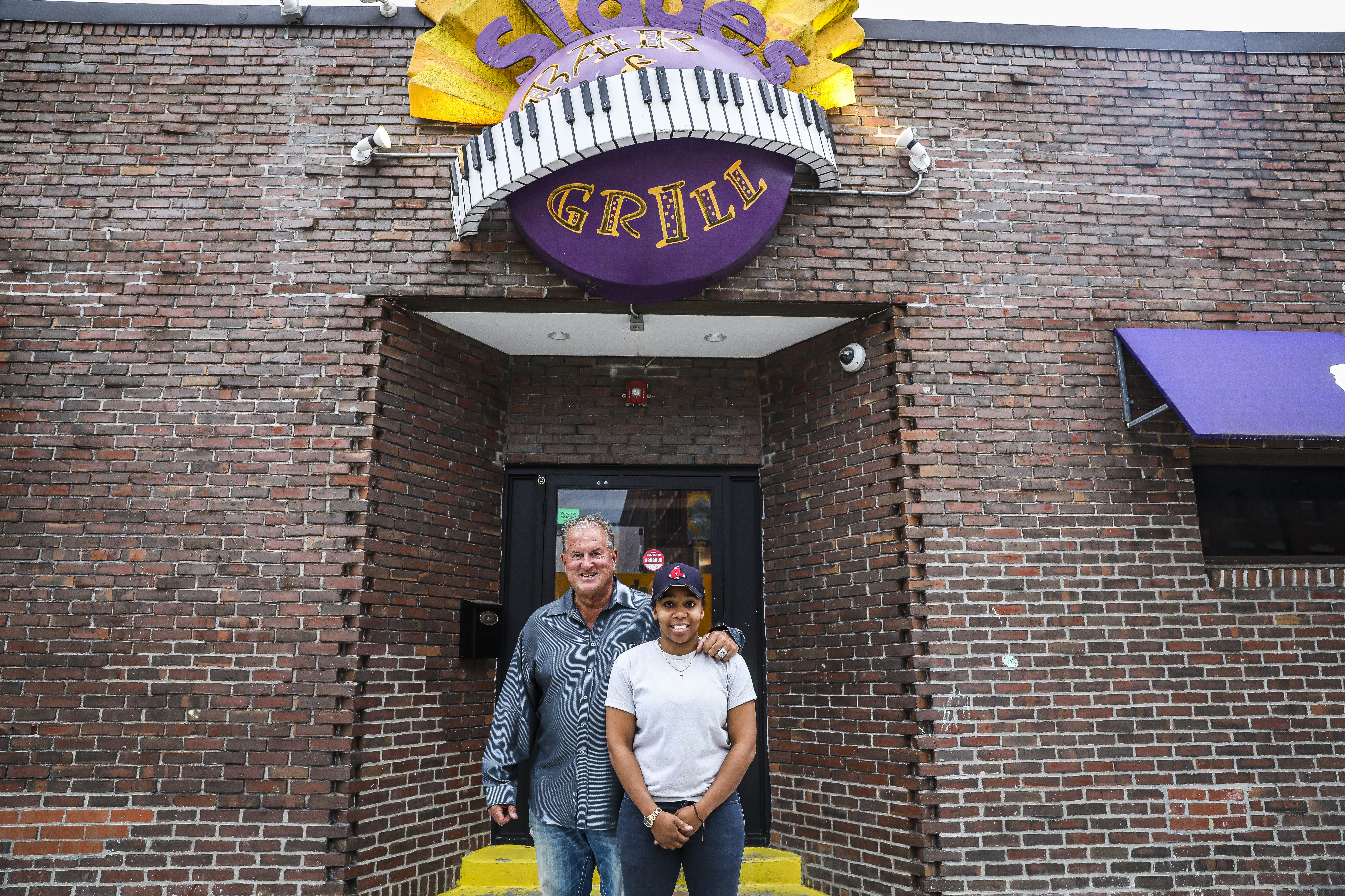 Slade's Bar & Grill owners, Leo Papile and his daughter, Britney Kyle Papile, in front of their restaurant.