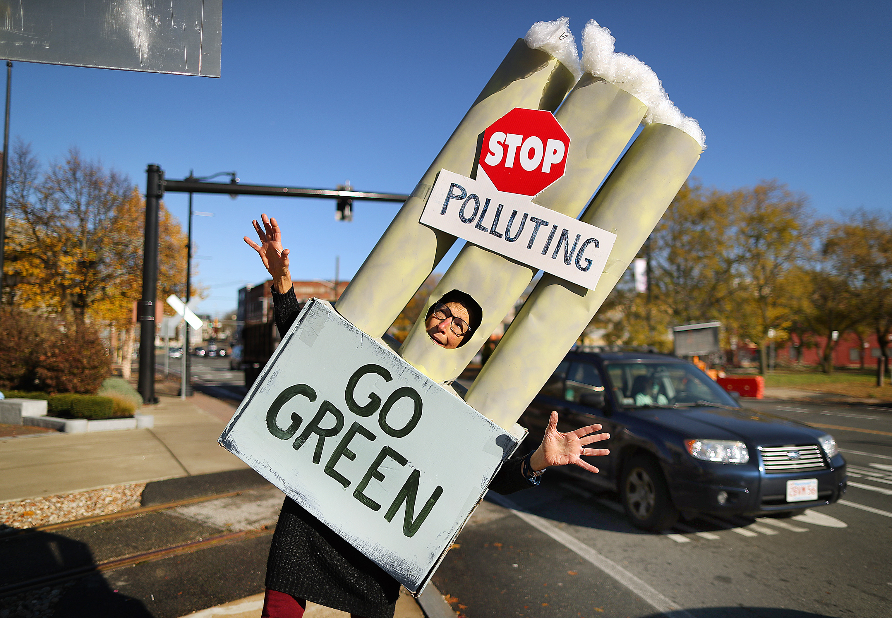 Judith Black from Marblehead walks dressed as a power plant smoke stack.