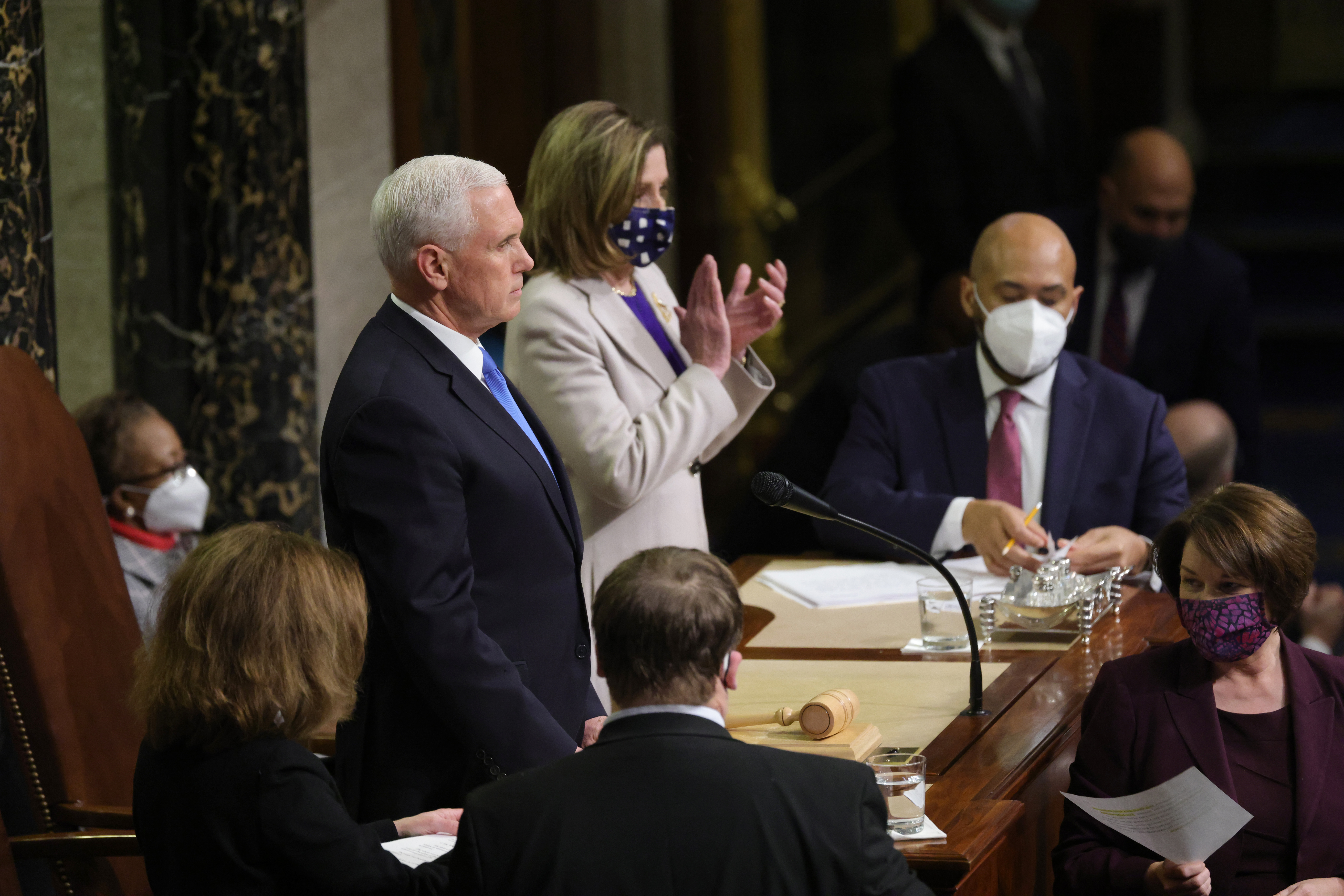 Vice President Mike Pence and Speaker of the House Nancy Pelosi looked on as the the count of electoral votes continued in the House Chamber during a reconvening of a joint session of Congress on Jan. 7.