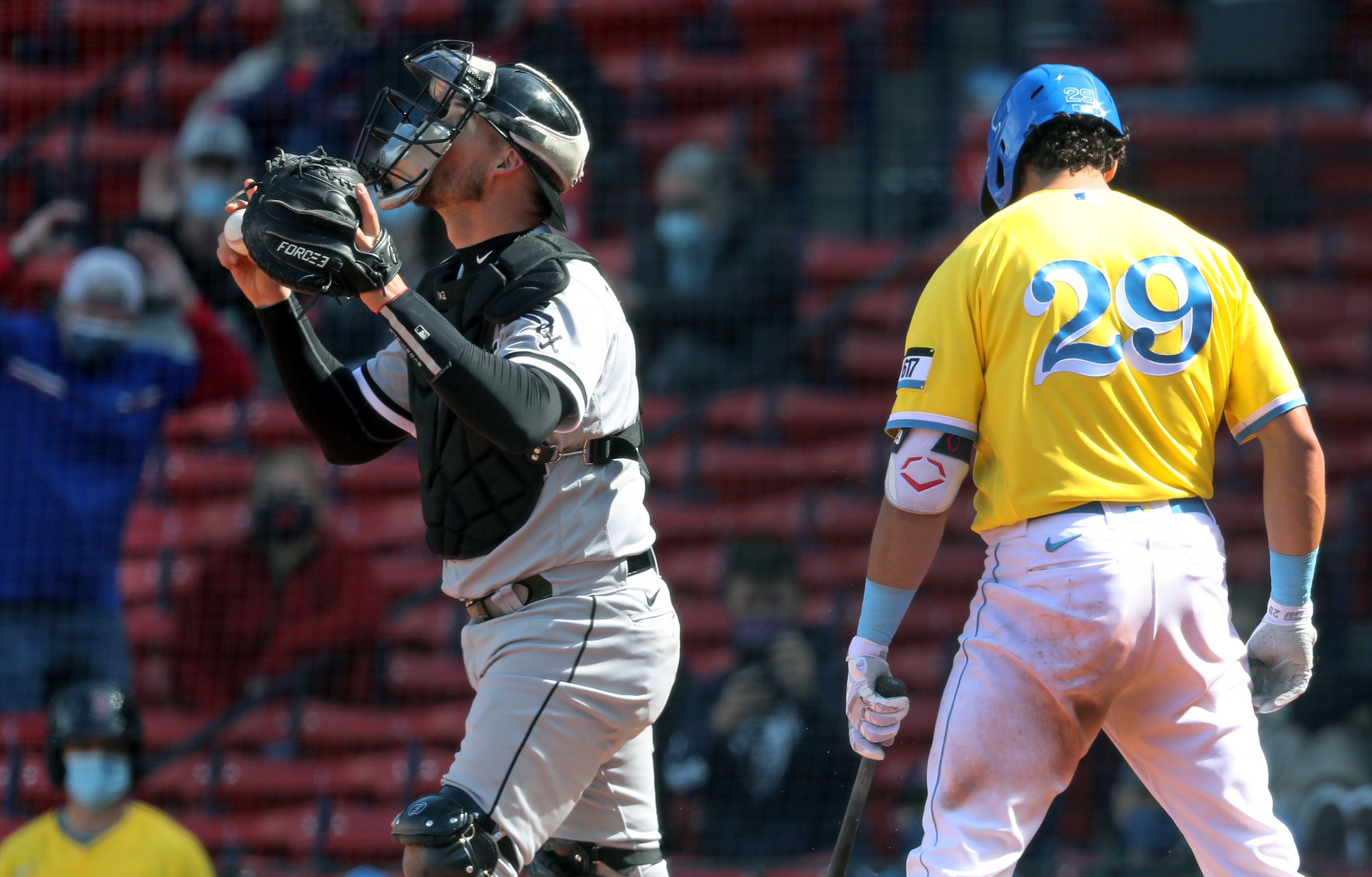 Bobby Dalbec can only walk away from home plate, and a celebrating White Sox catcher Yasmani Grandal, after being called out on strikes to end Sunday's Game 1.