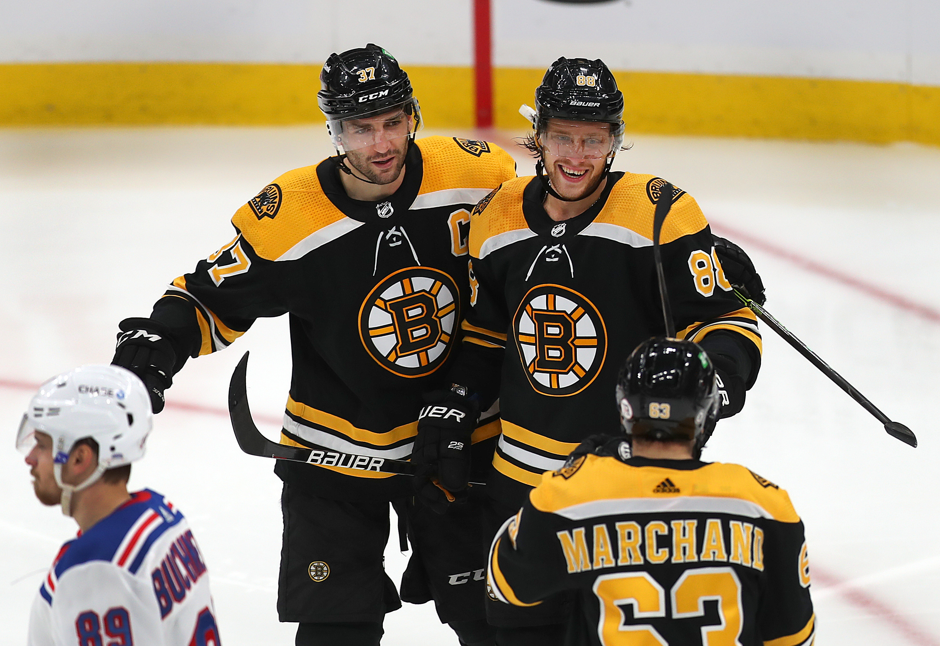 All three members of Boston's top line had goals on Saturday, David Pastrnak (right) putting the Bruins ahead 21 seconds into the second and Brad Marchand and Patrice Bergeron (left) each pulling them back within one late.