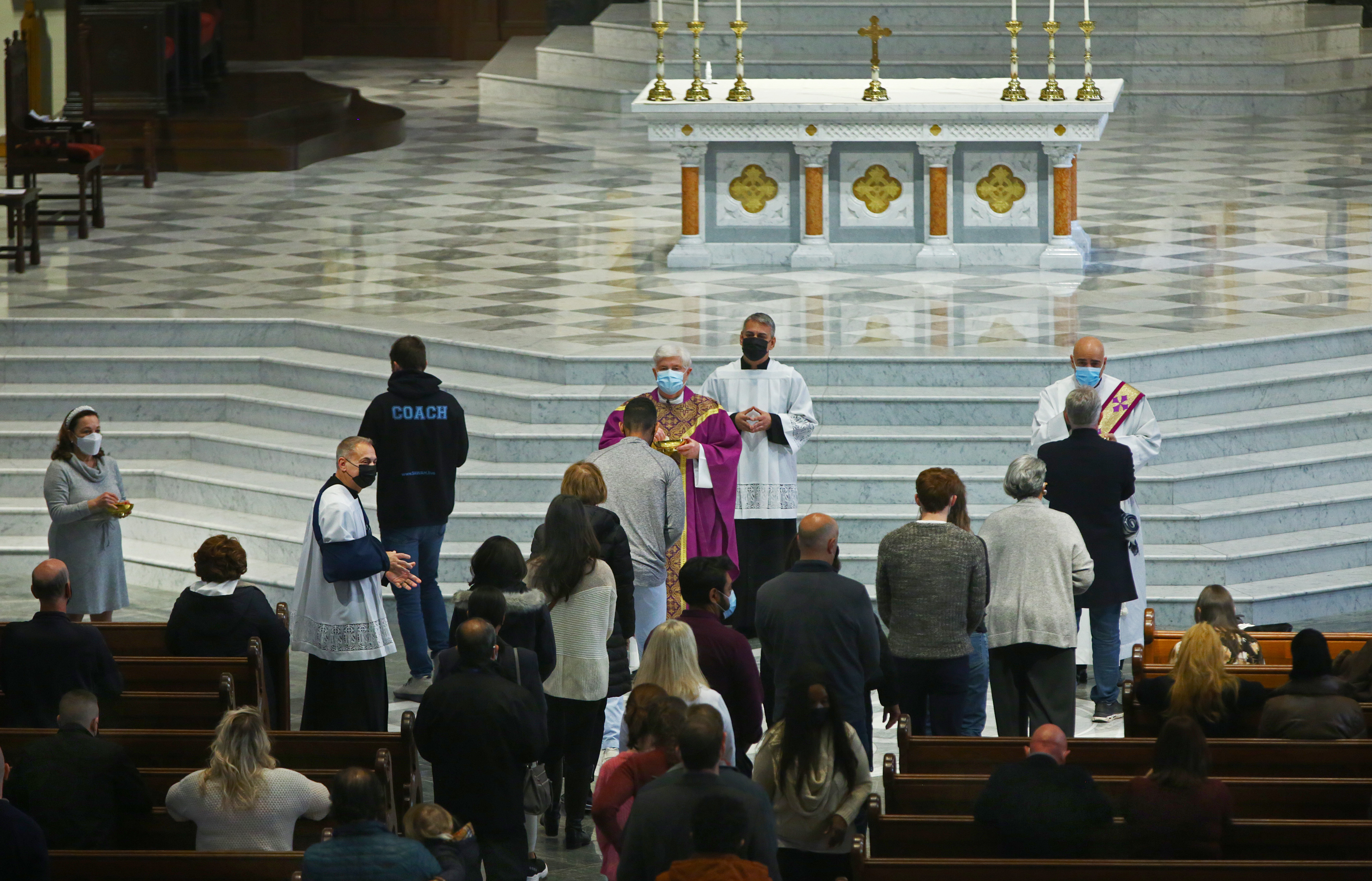 Monsignor Kevin O'Leary (purple clothes) celebrated Holy Communion.