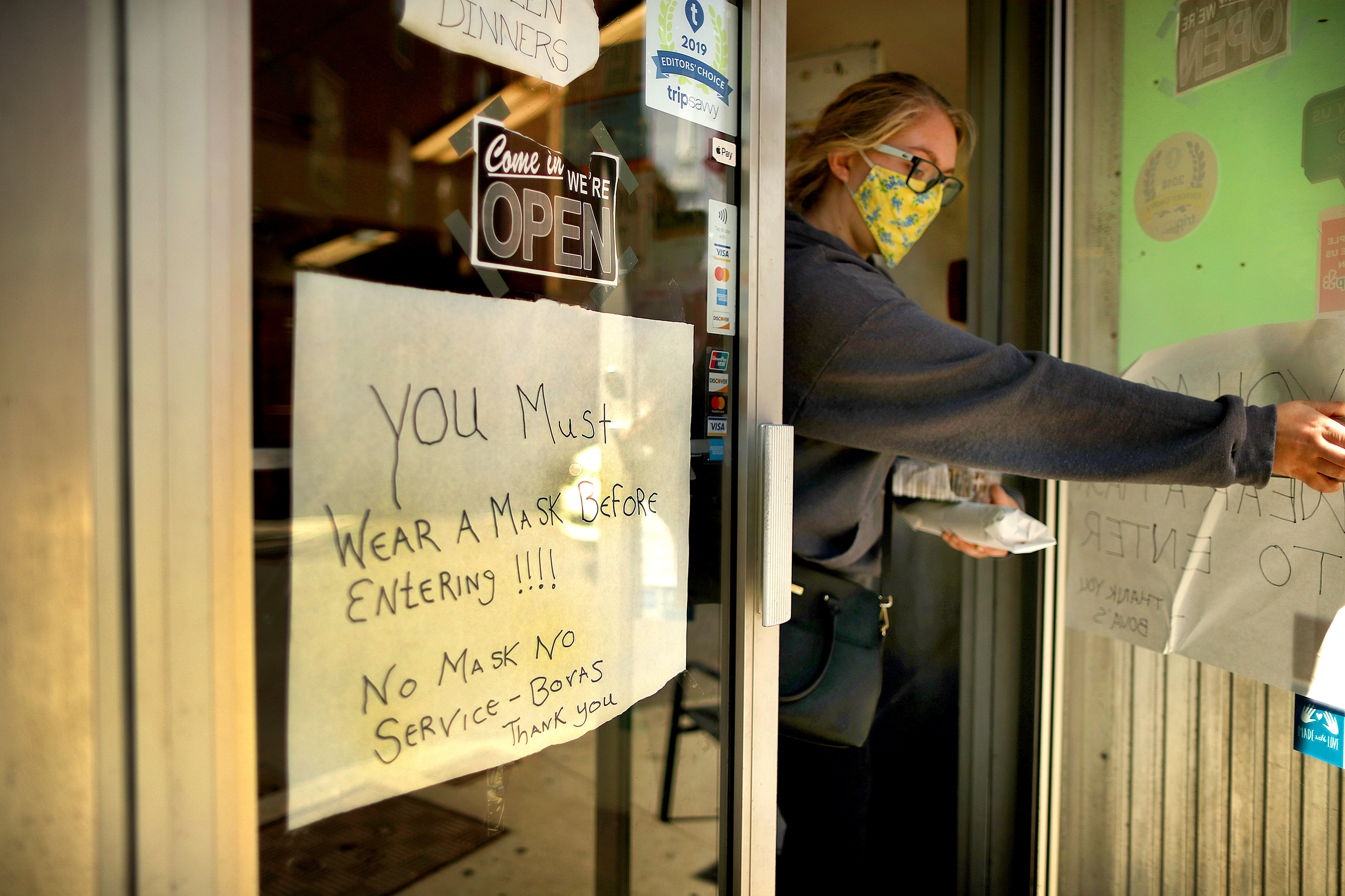 A woman left Bova's Bakery on Salem Street with a warning sign on the door.