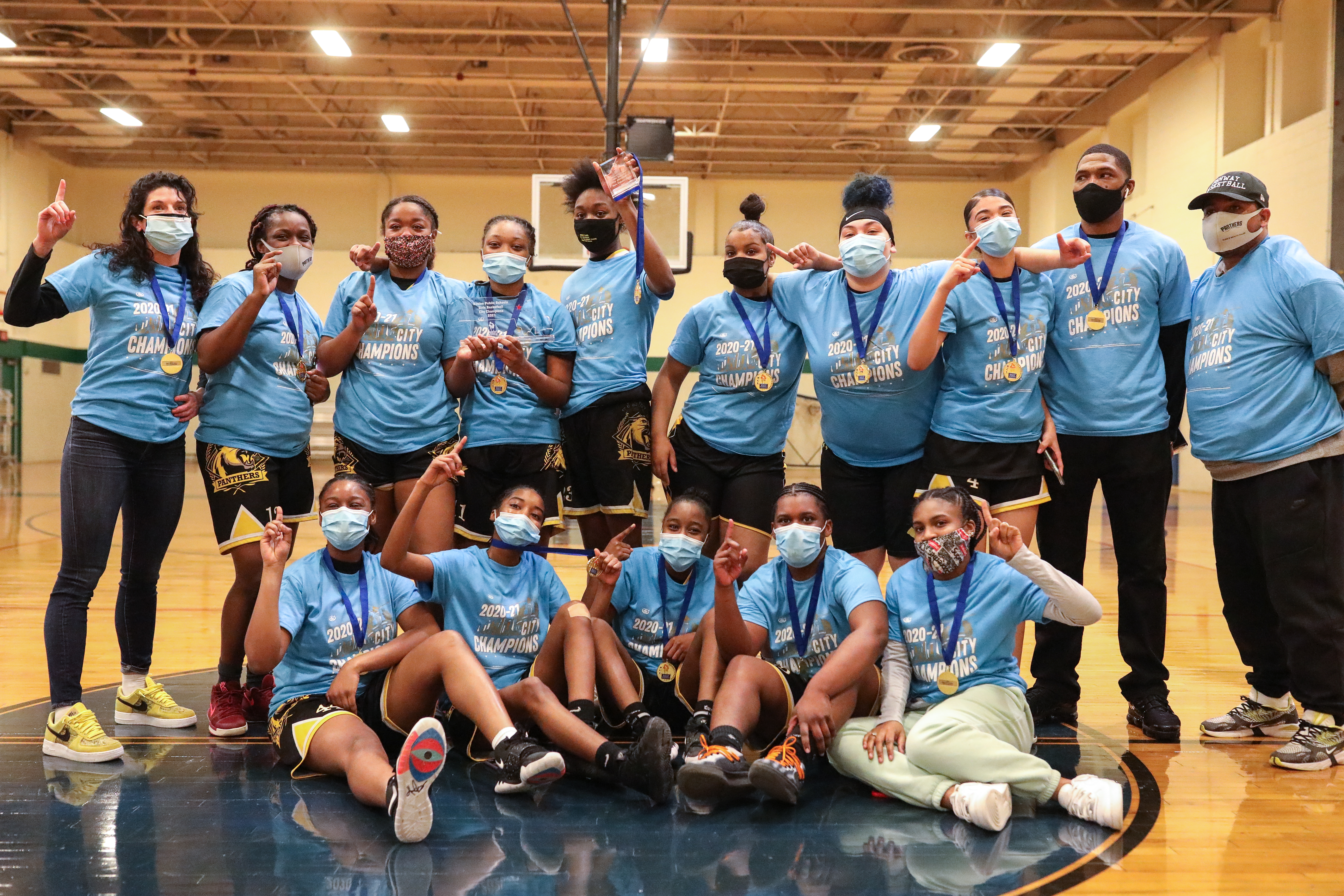 The Fenway girls' basketball team poses after winning its fourth consecutive Boston City League championship.