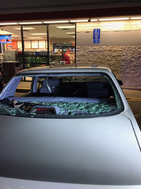 Photos taken after the attack show the back and side windows of the man's car smashed in.