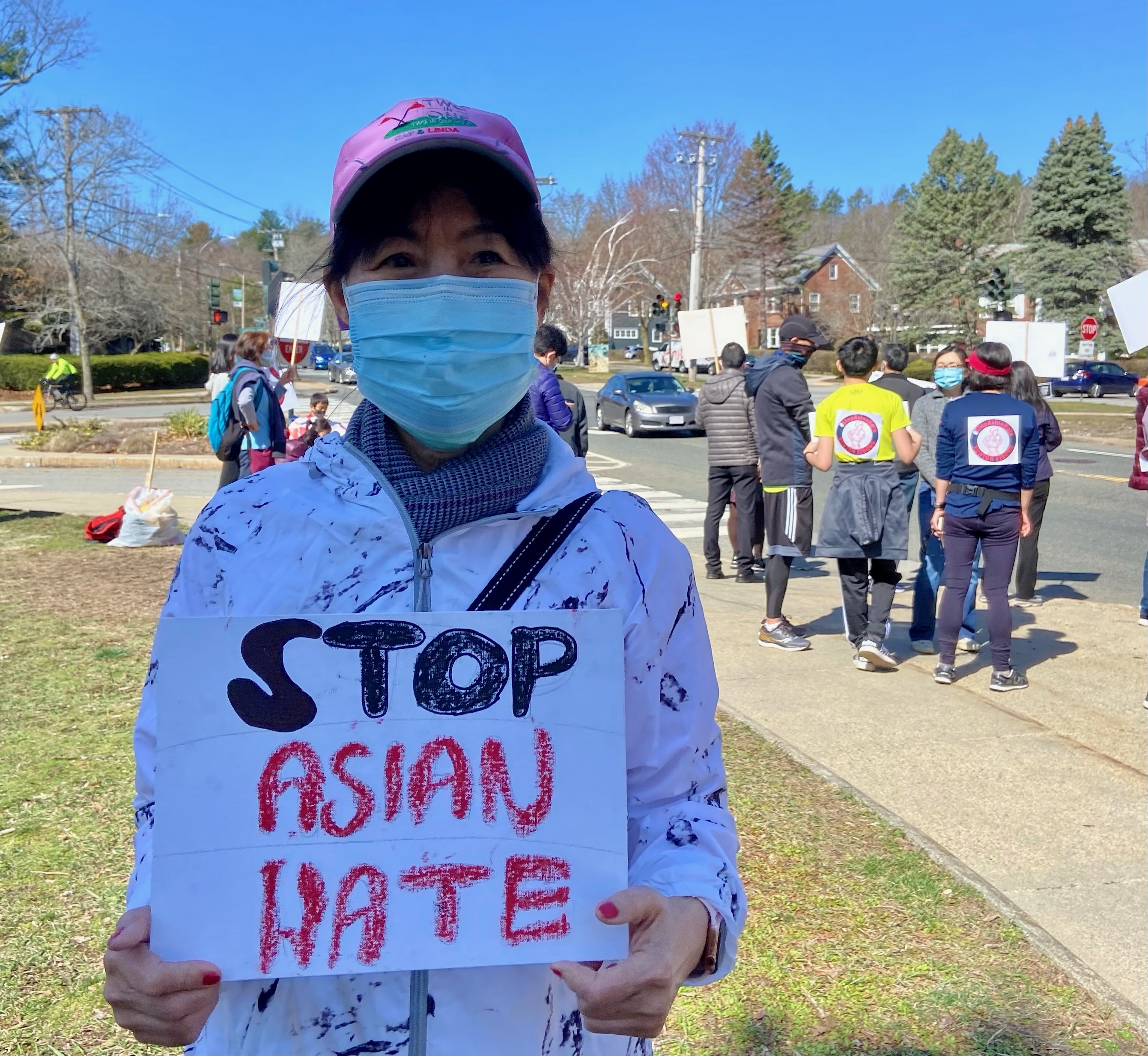 Vicki Ni, GBCCA vice president, holding a sign as she cheered on runners at the Stop Hate Rally and Run on March 27.