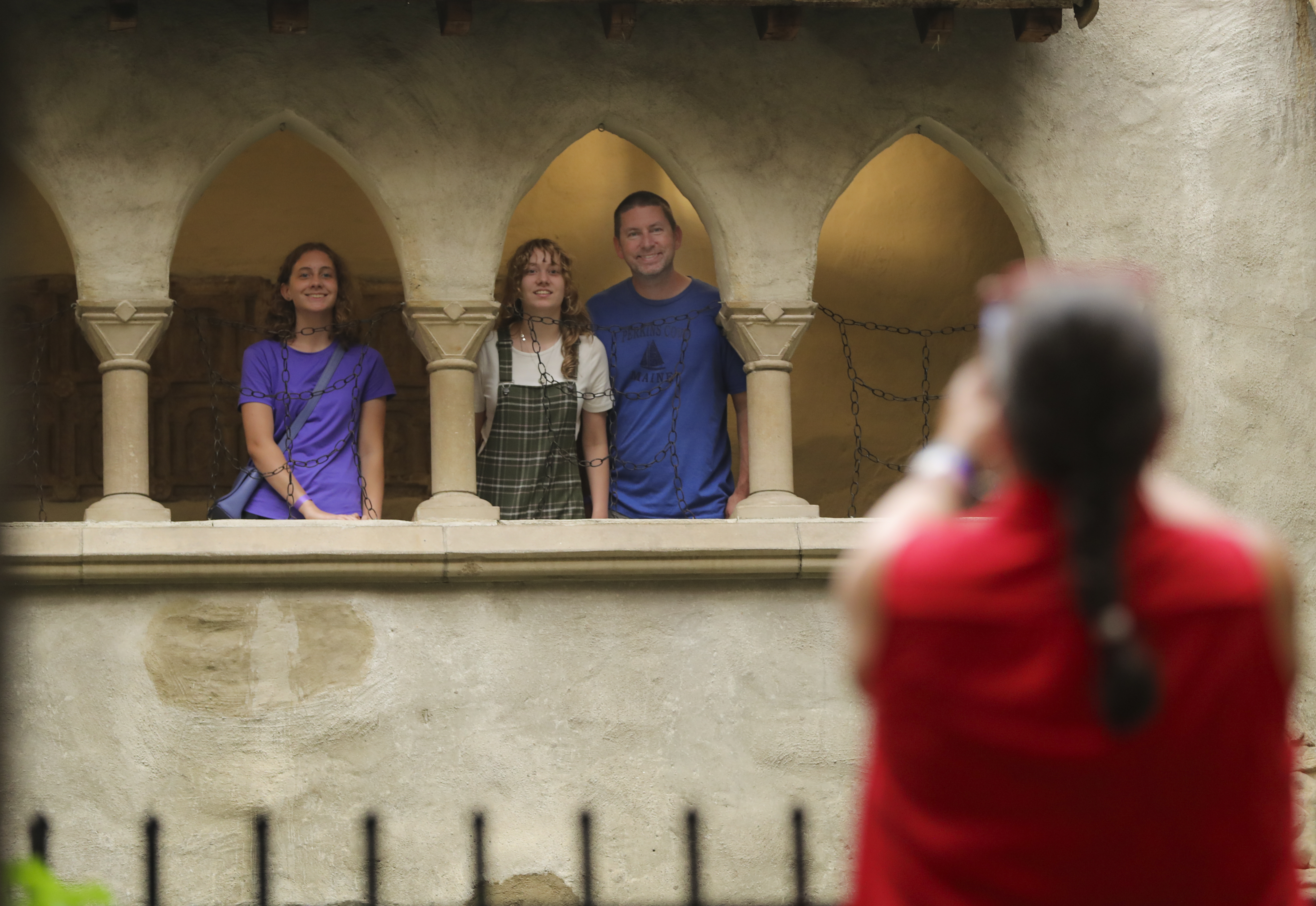 Lisa Ehleringer takes a picture of her daughers (from left), Vivi, 17, Lizzy, 13, and Lisa's husband Jeff Ehleringer in the indoor courtyard at the Hammond Castle Museum. 