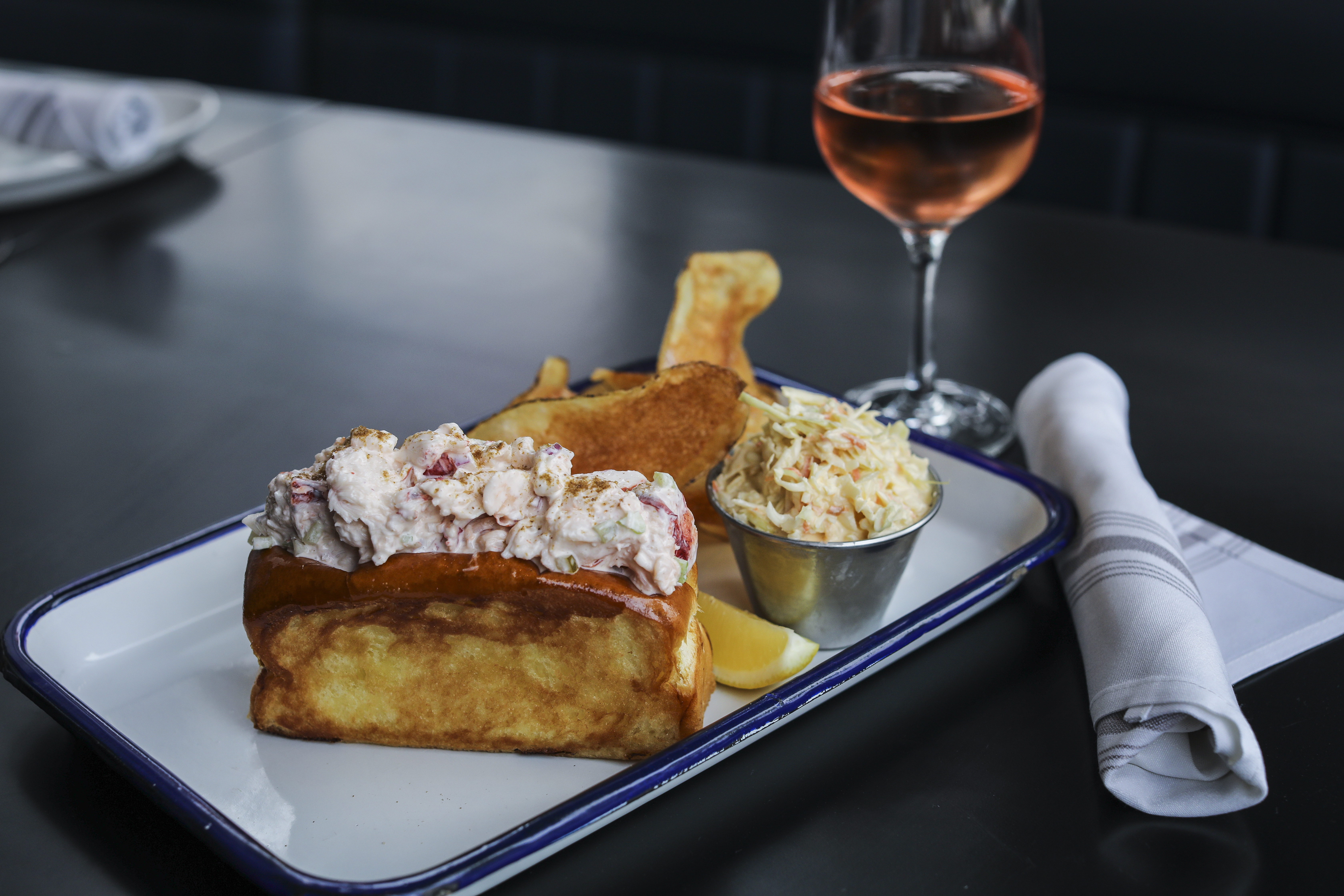 Ethel's Creamy Lobster Roll served on brioche bread with homemade french fries and coleslaw. 