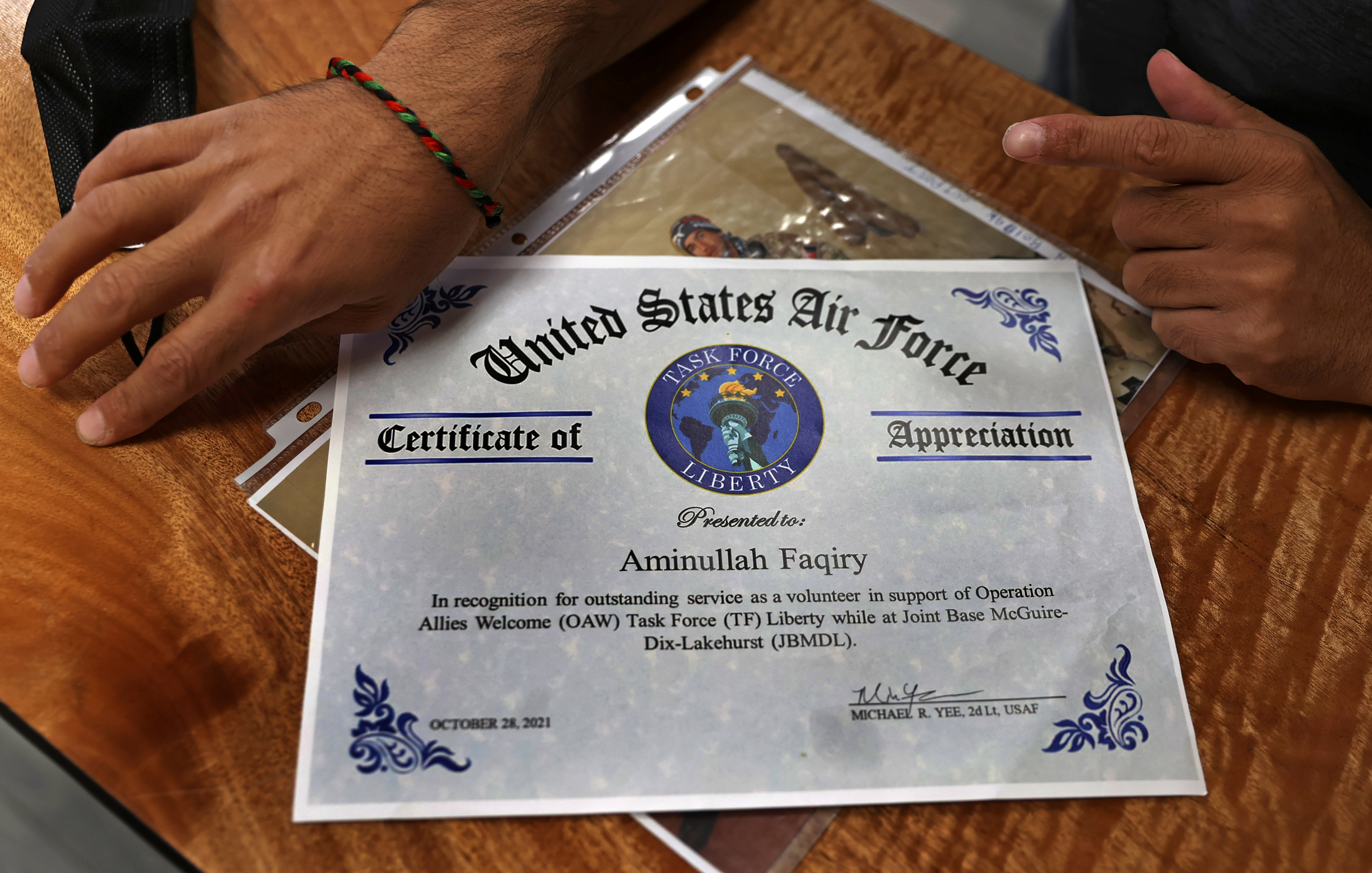 A certificate of appreciation was given to Aminullah Faqiry, an Afghan interpreter for the US military who just arrived in Rhode Island with his family.
