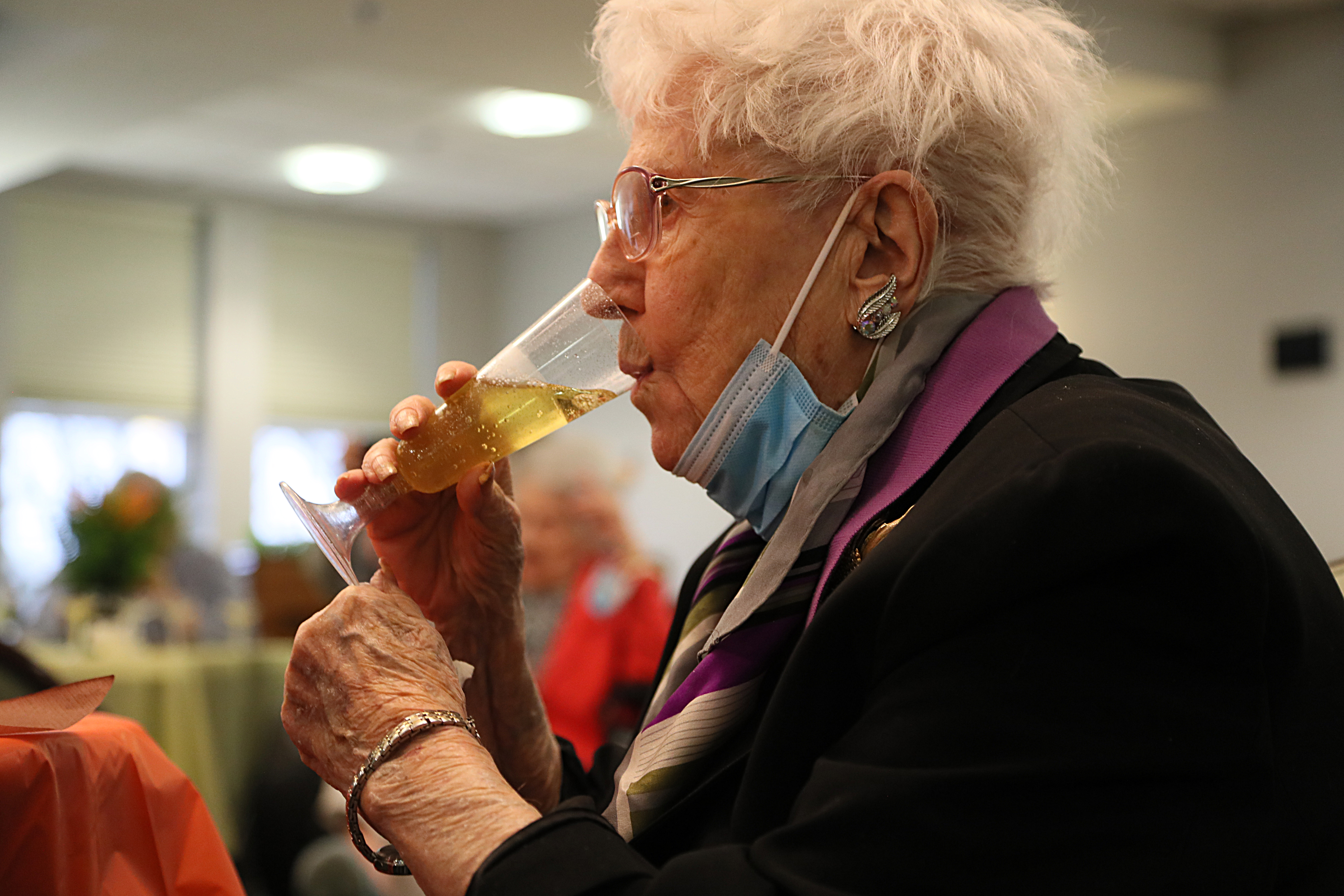 Thelma Tayor, 100, tasted sparkling cider during the party.  