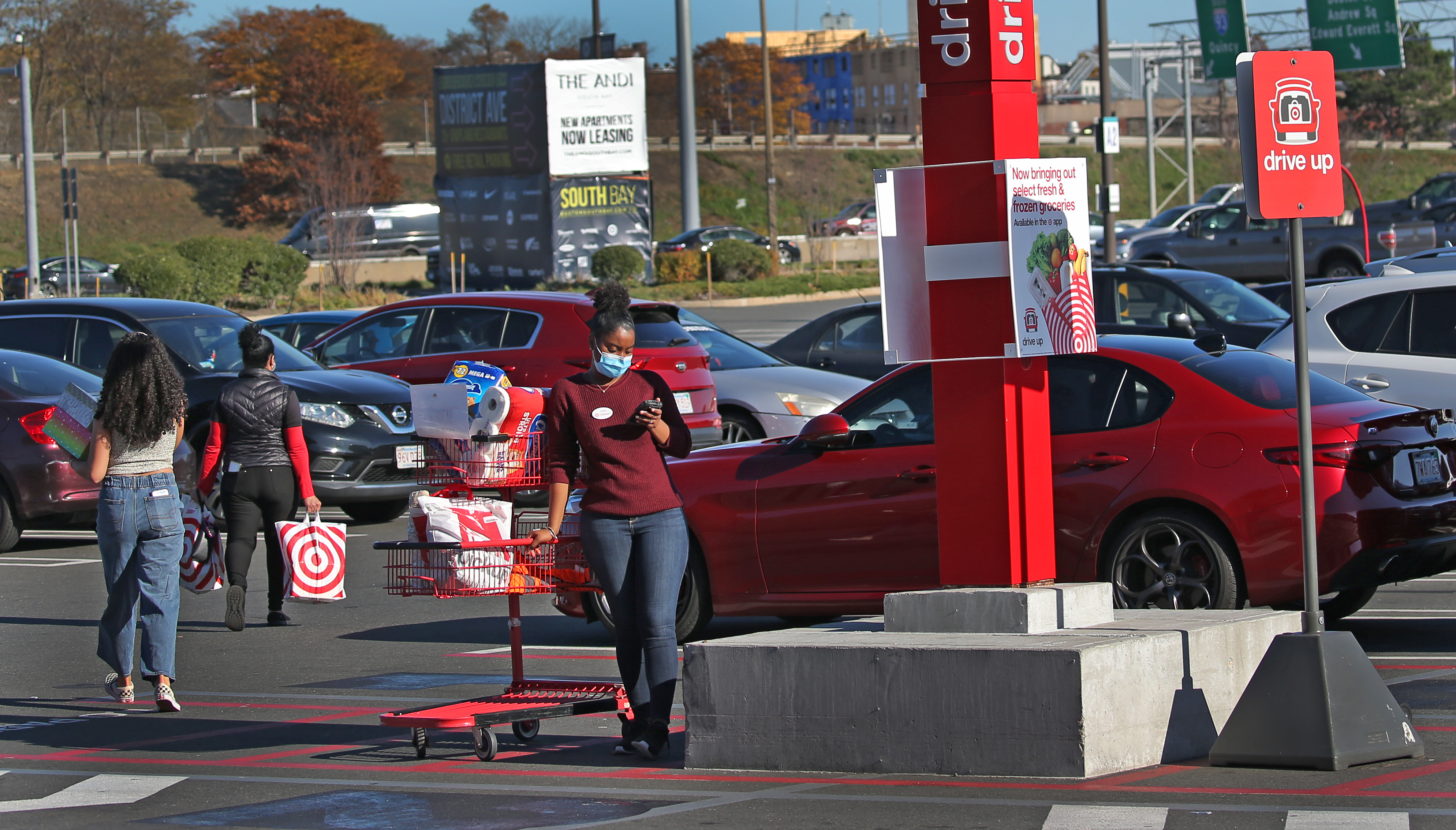 At Target in South Bay, an employee waits with a shopping cart for a customer to arrive for a pickup.