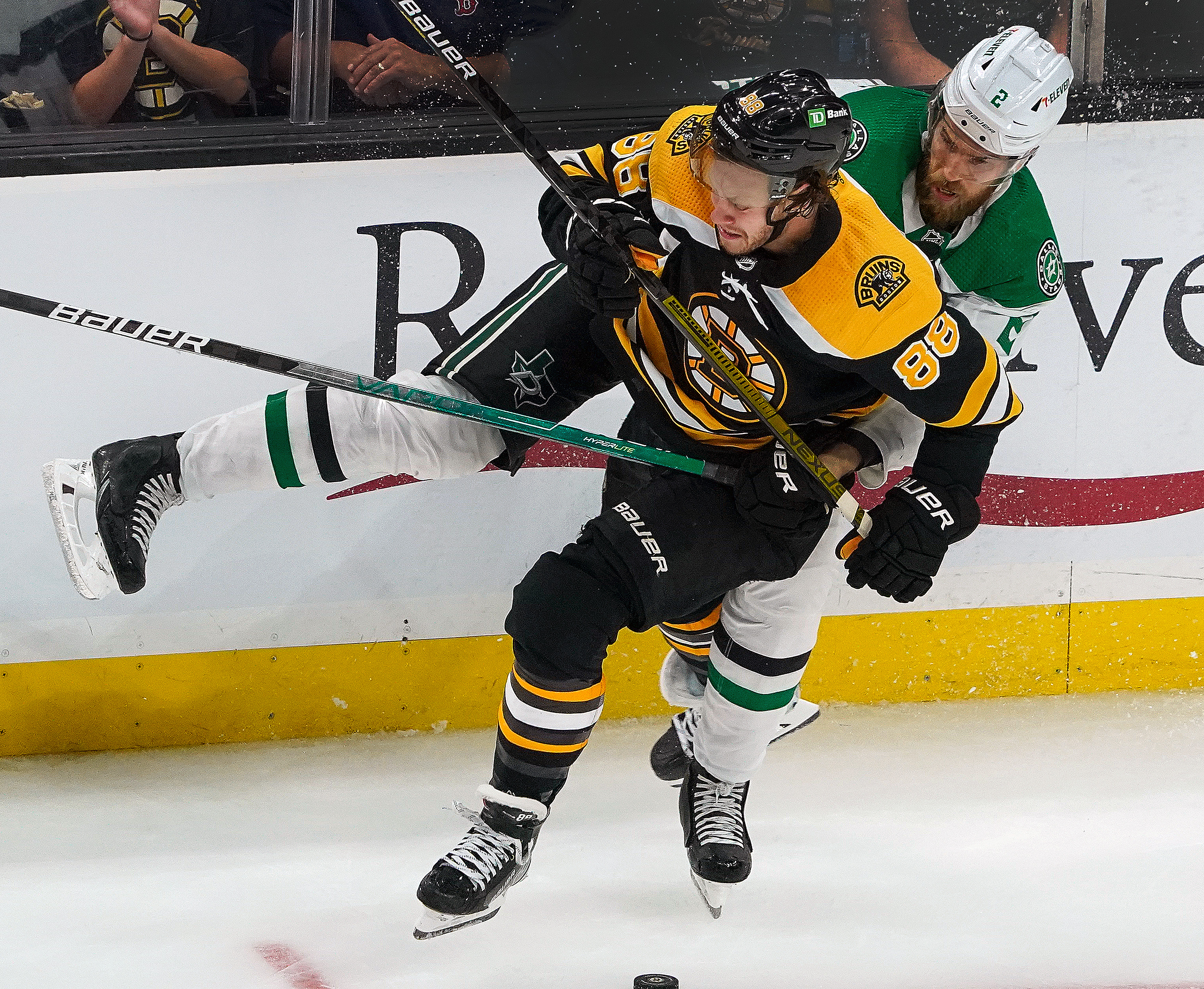 Bruins right wing David Pastrnak takes a heavy hit from Dallas Stars defenseman Jani Hakanpaa during the third period.