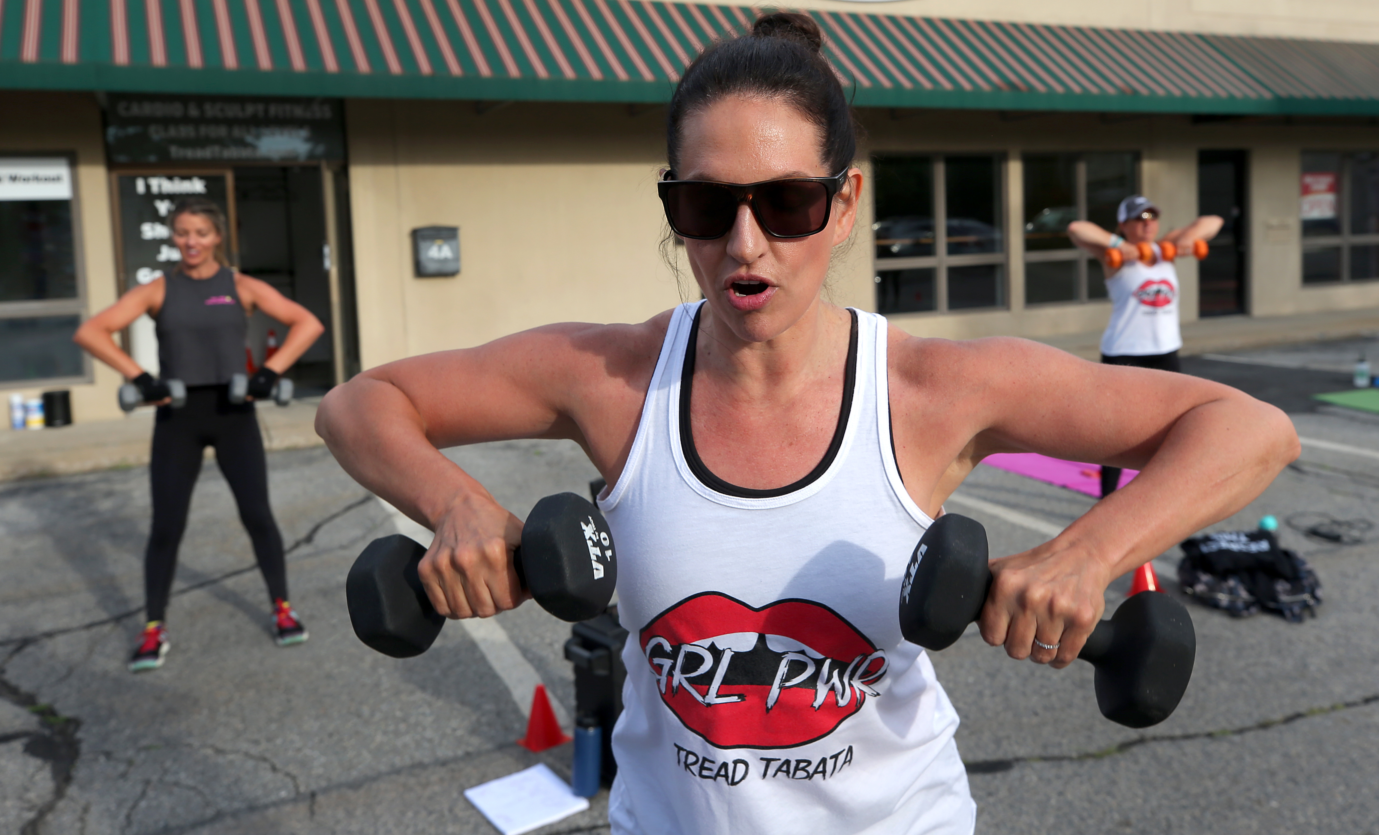Tread Tabata owner Kathy Glabicky instructed an outdoor class in the parking lot of her Beverly studio during the COVID-19 pandemic in June 2020. 