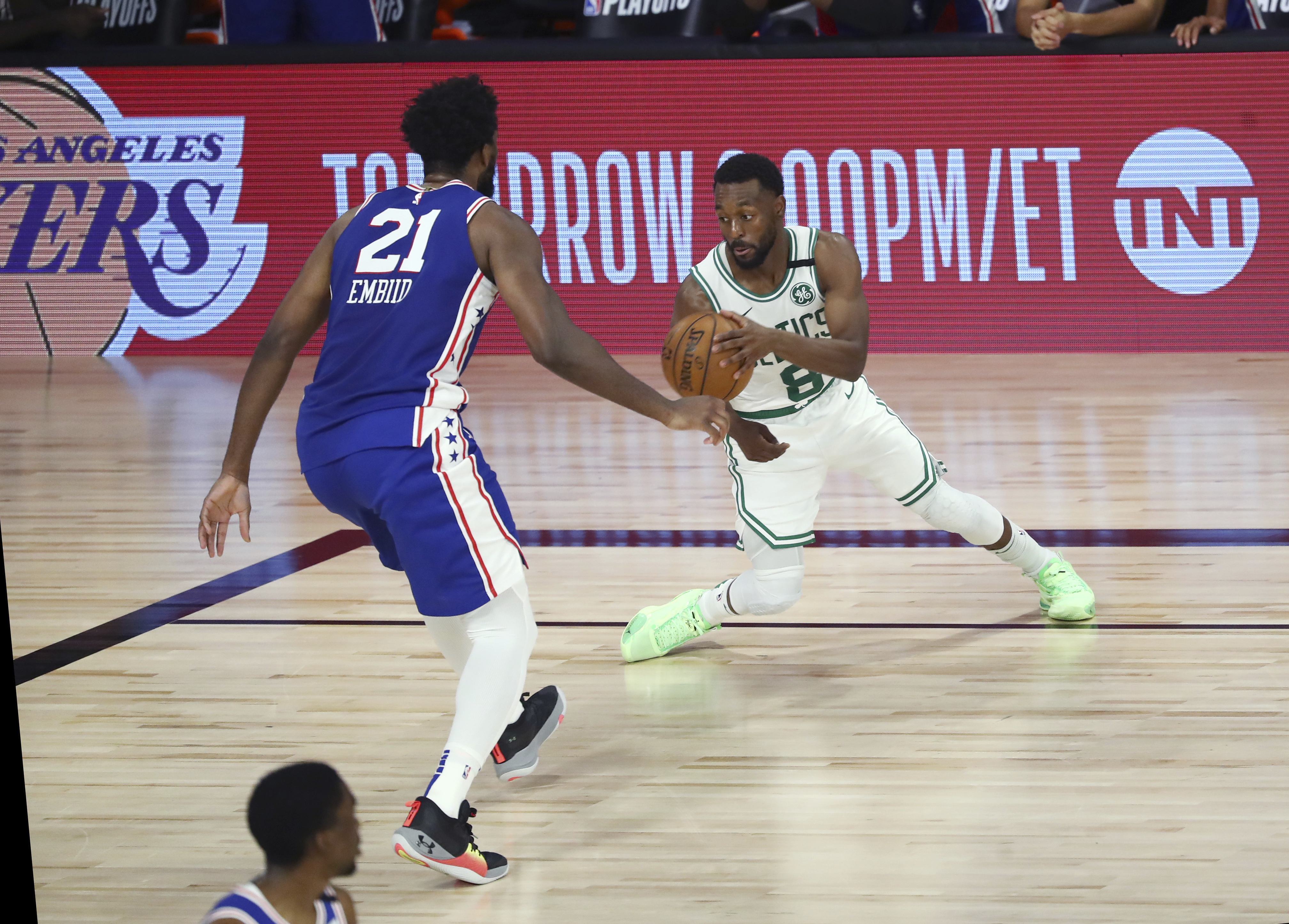 Kemba Walker drives to the basket against Philadelphia's Joel Embiid during the second quarter of Sunday's game.