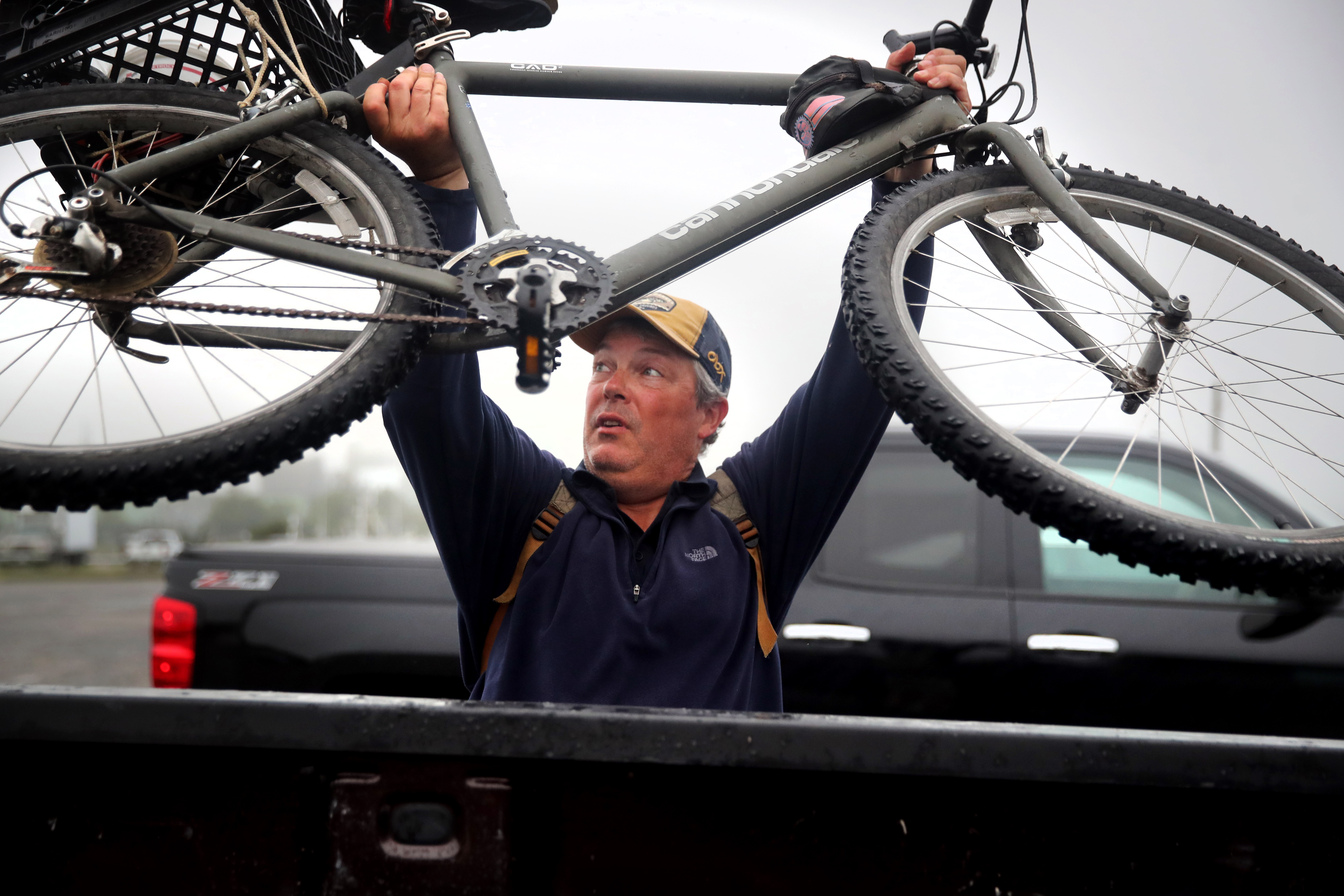 Fisherman Matt Bryant lifted his bike into his truck after fishing on the Cape Cod Canal. Bryant has been fishing since he was 5.