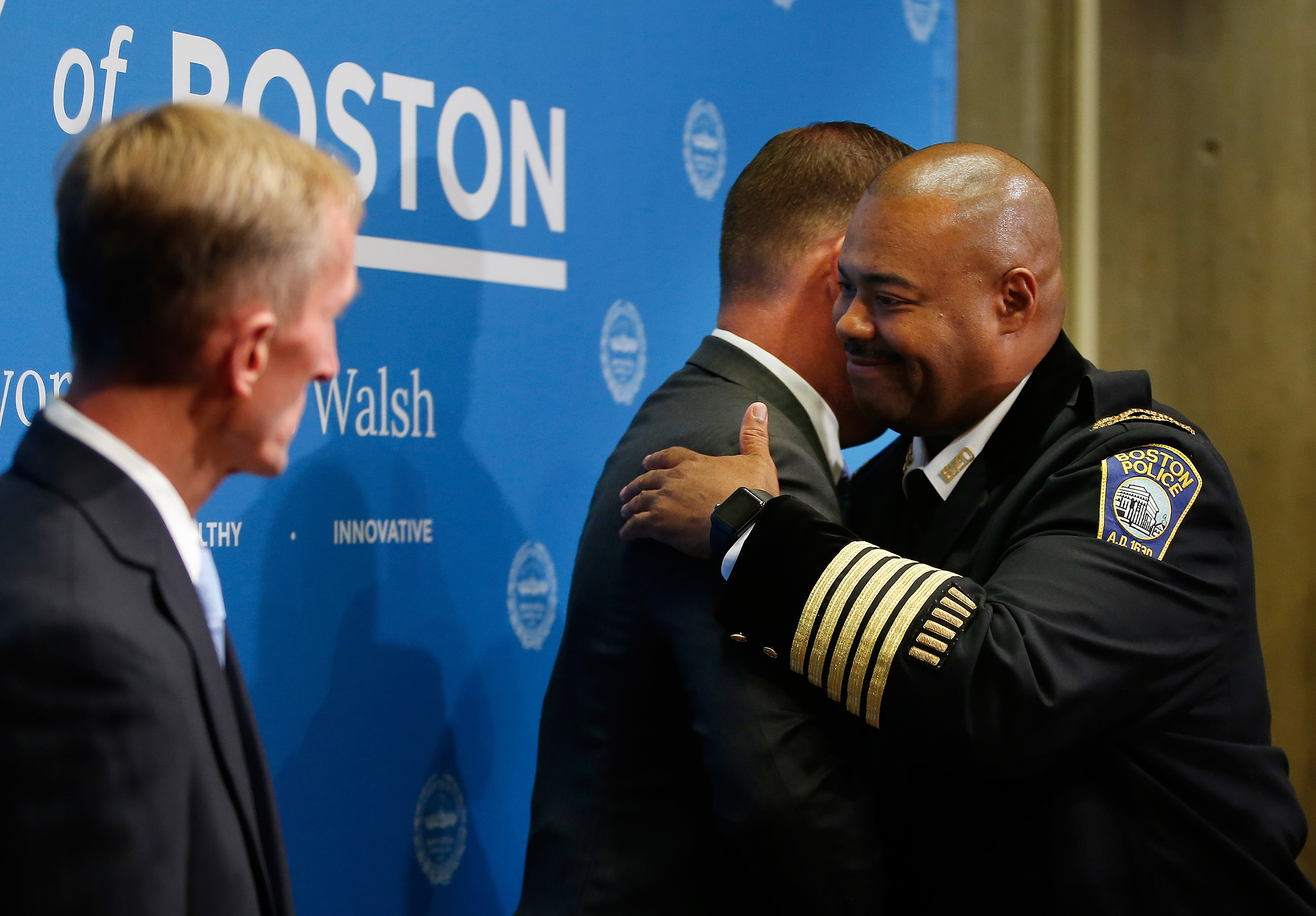Newly appointed Boston Police Commissioner William Gross hugged Mayor Walsh during a press conference at City Hall in 2018.