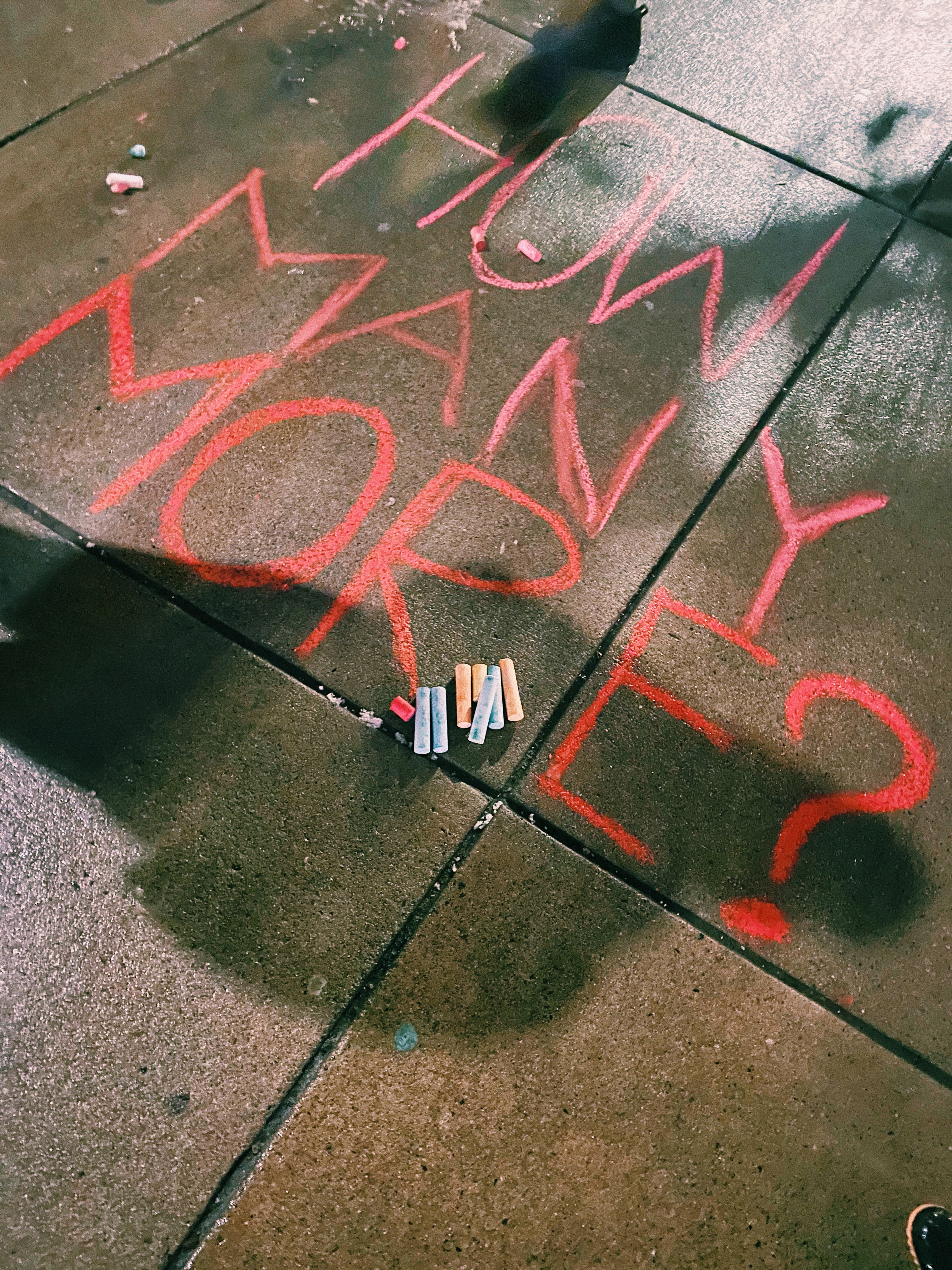 A chalk message that reads "How Many More?" that was written Sunday night.