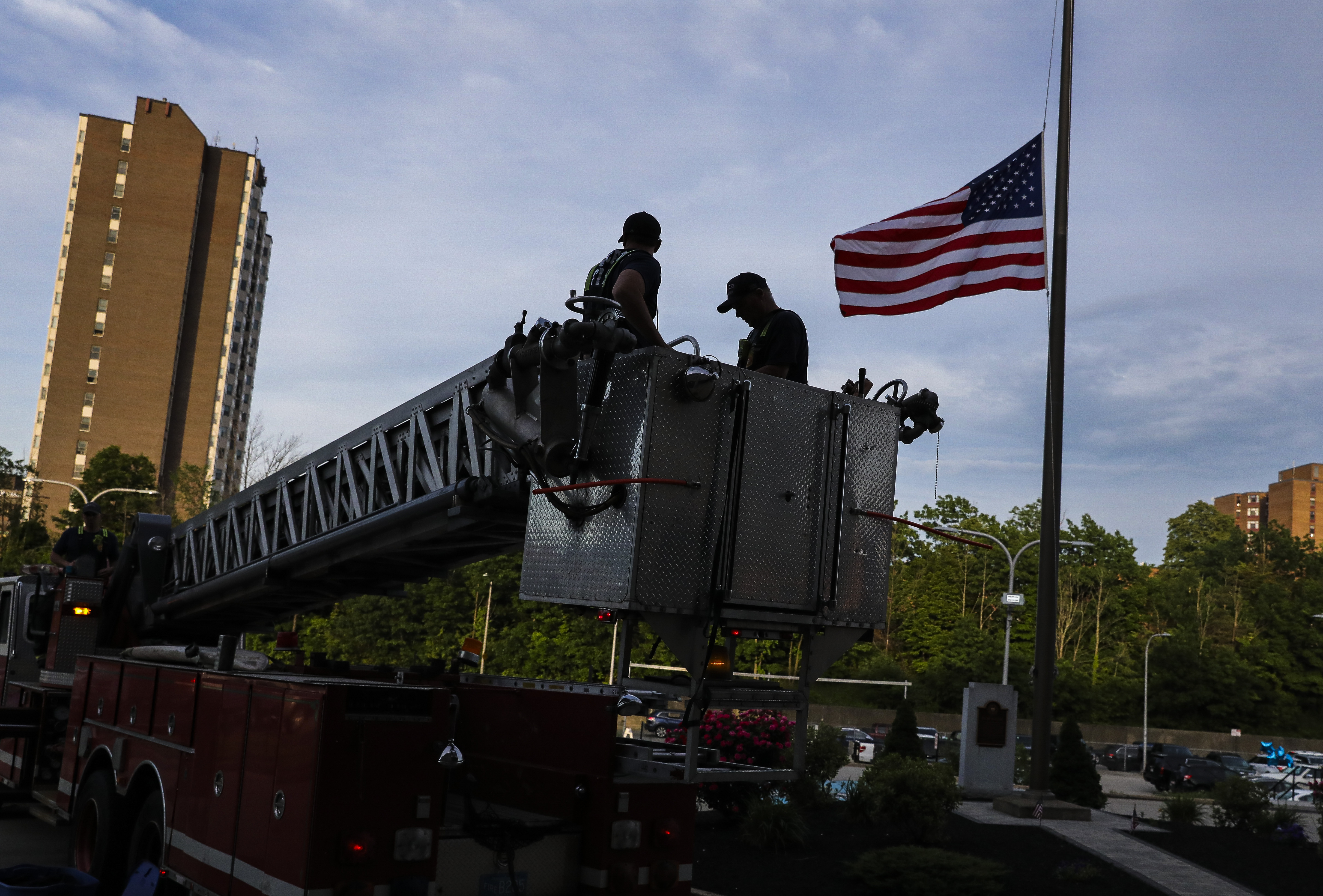 A flag flew at half-staff t as Worcester firefighters hung a black bunting on the police headquarters to honor the officer who drowned attempting to save a teen from Green Hill Pond on Friday afternoon.