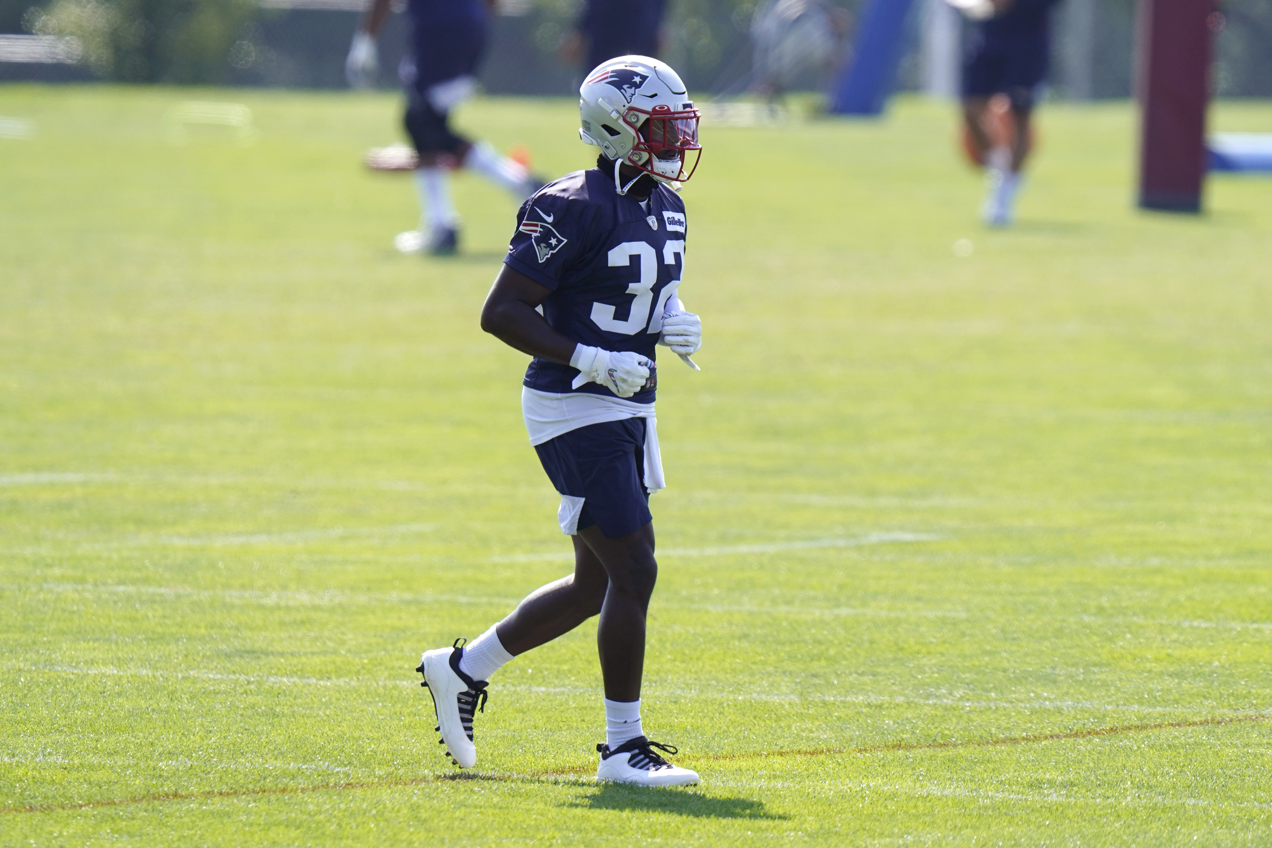 Devin McCourty warms up prior to Sunday's practice in Foxborough.