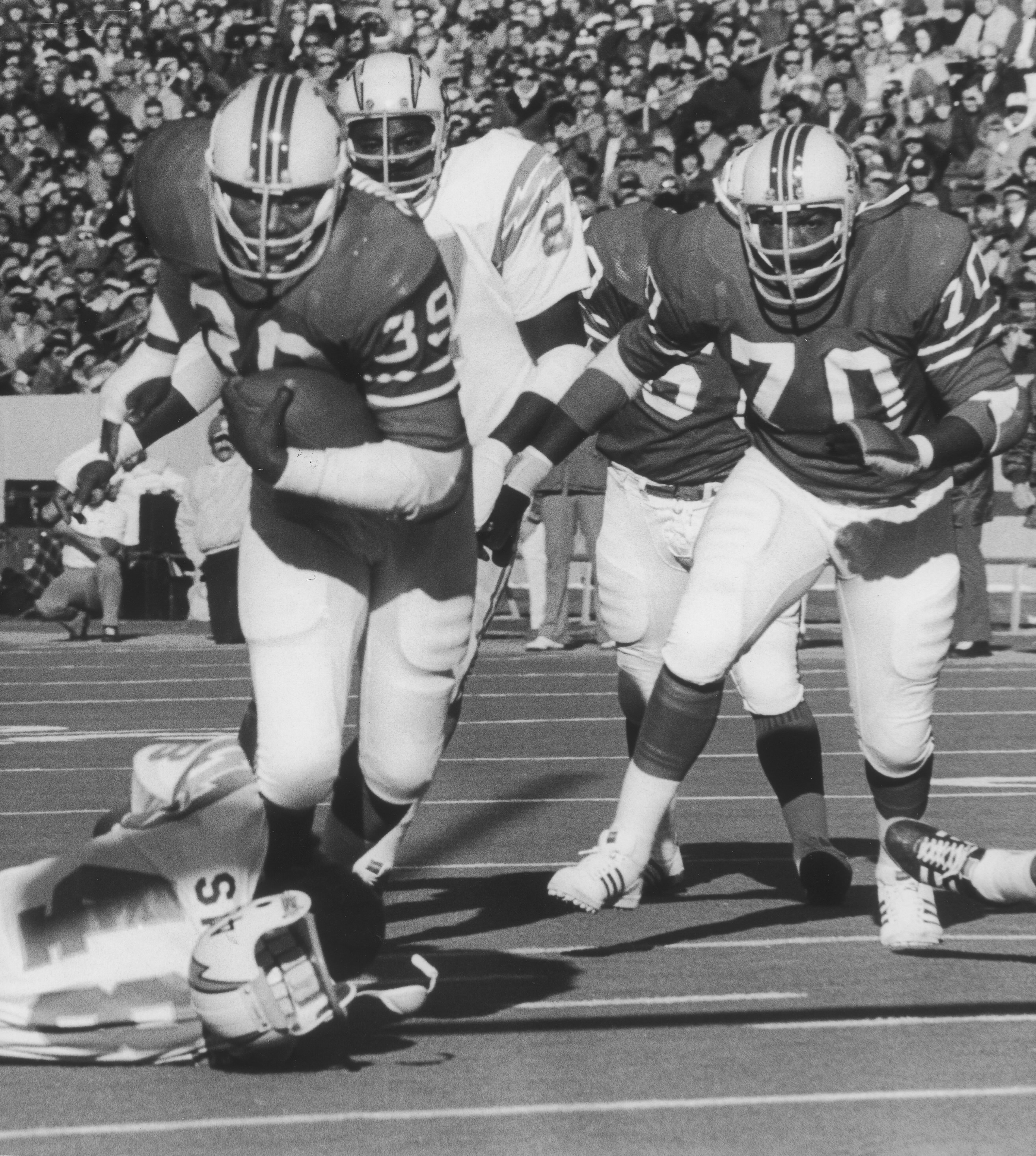 Mr. Cunningham, with lineman Leon Gray, cutting through the San Diego Chargers defense.