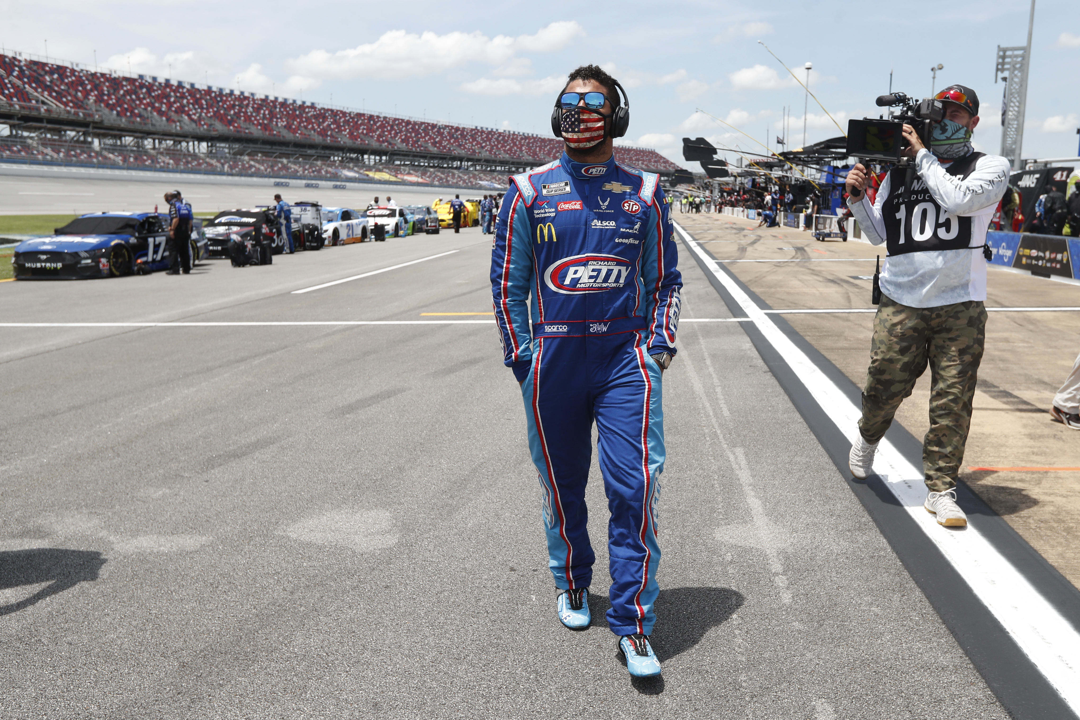 Bubba Wallace walks through the pits prior to the start of the NASCAR Cup Series at the Talladega Superspeedway on Monday.