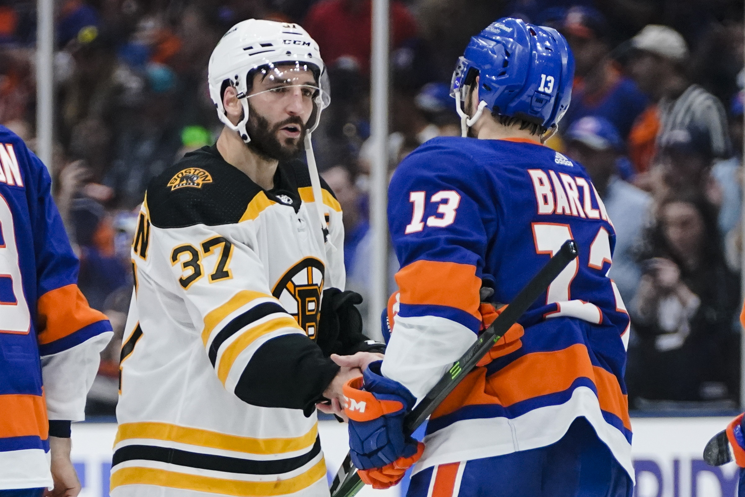 Patrice Bergeron shakes hands with New York's Mathew Barzal after Boston's Game 6 loss Wednesday night.