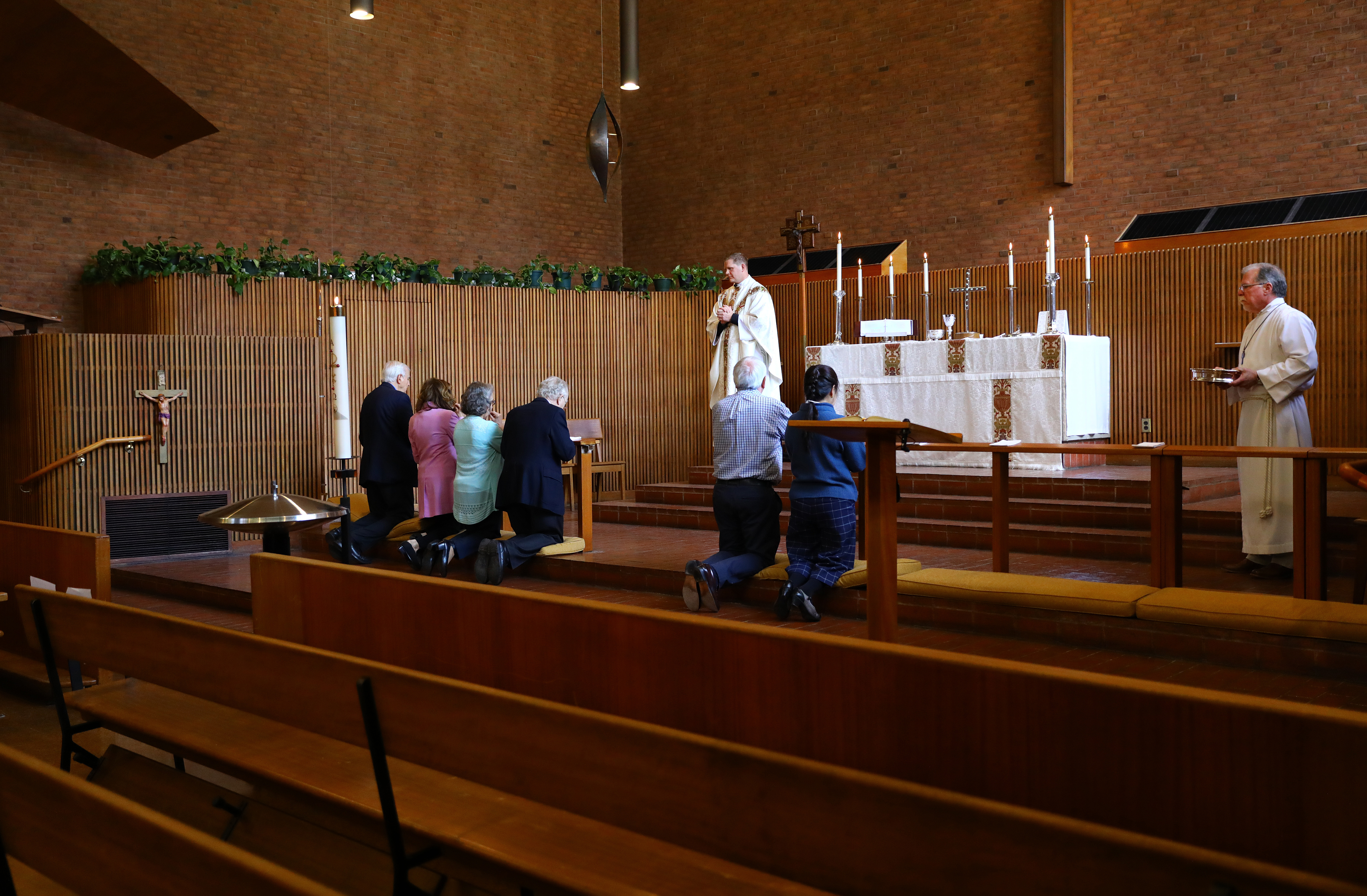 In a change, Communion gifts are placed at the altar rail before worshipers approach.
