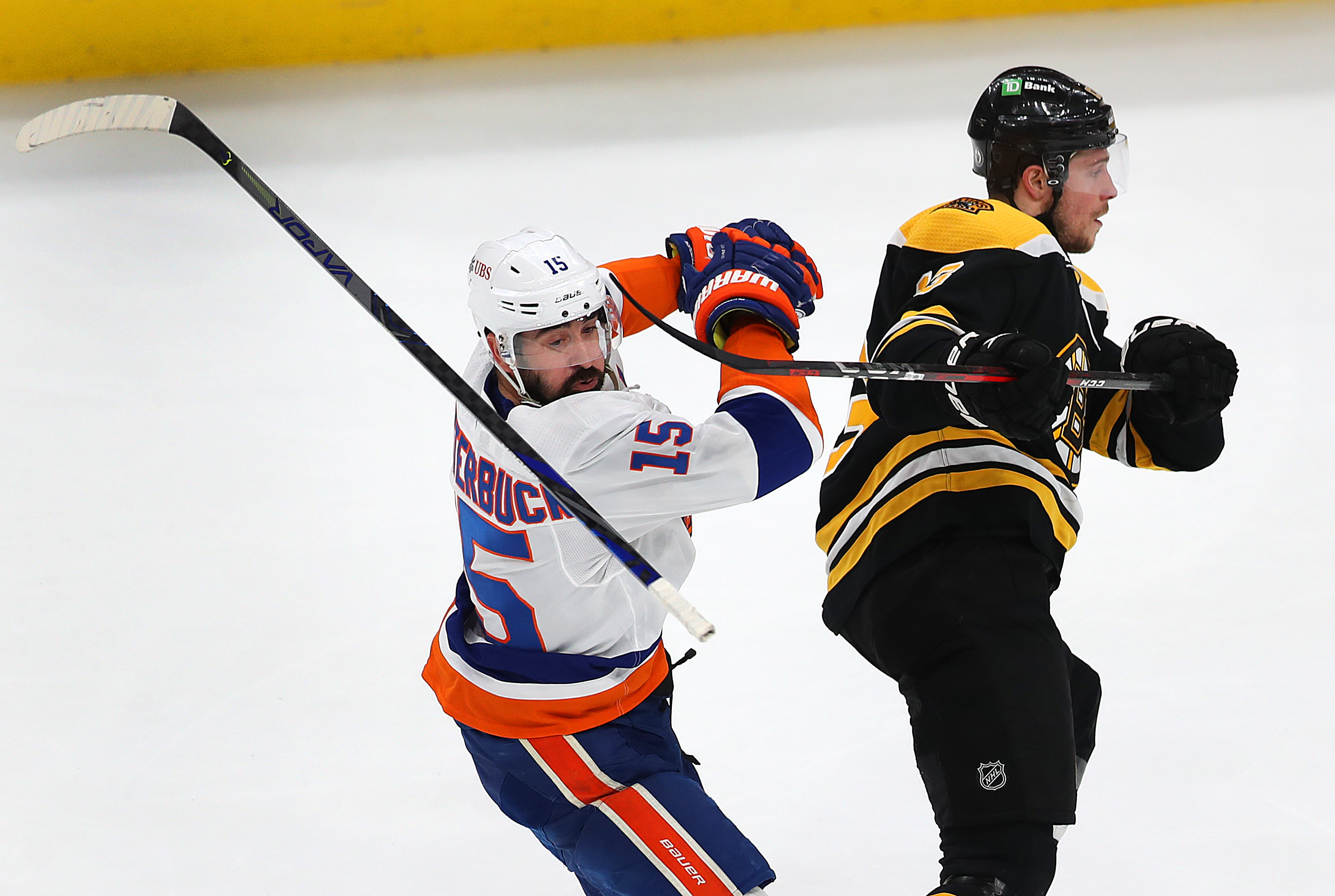 The Islanders' Cal Clutterbuck loses his stick in a tangle with the Bruins' Charlie Coyle.