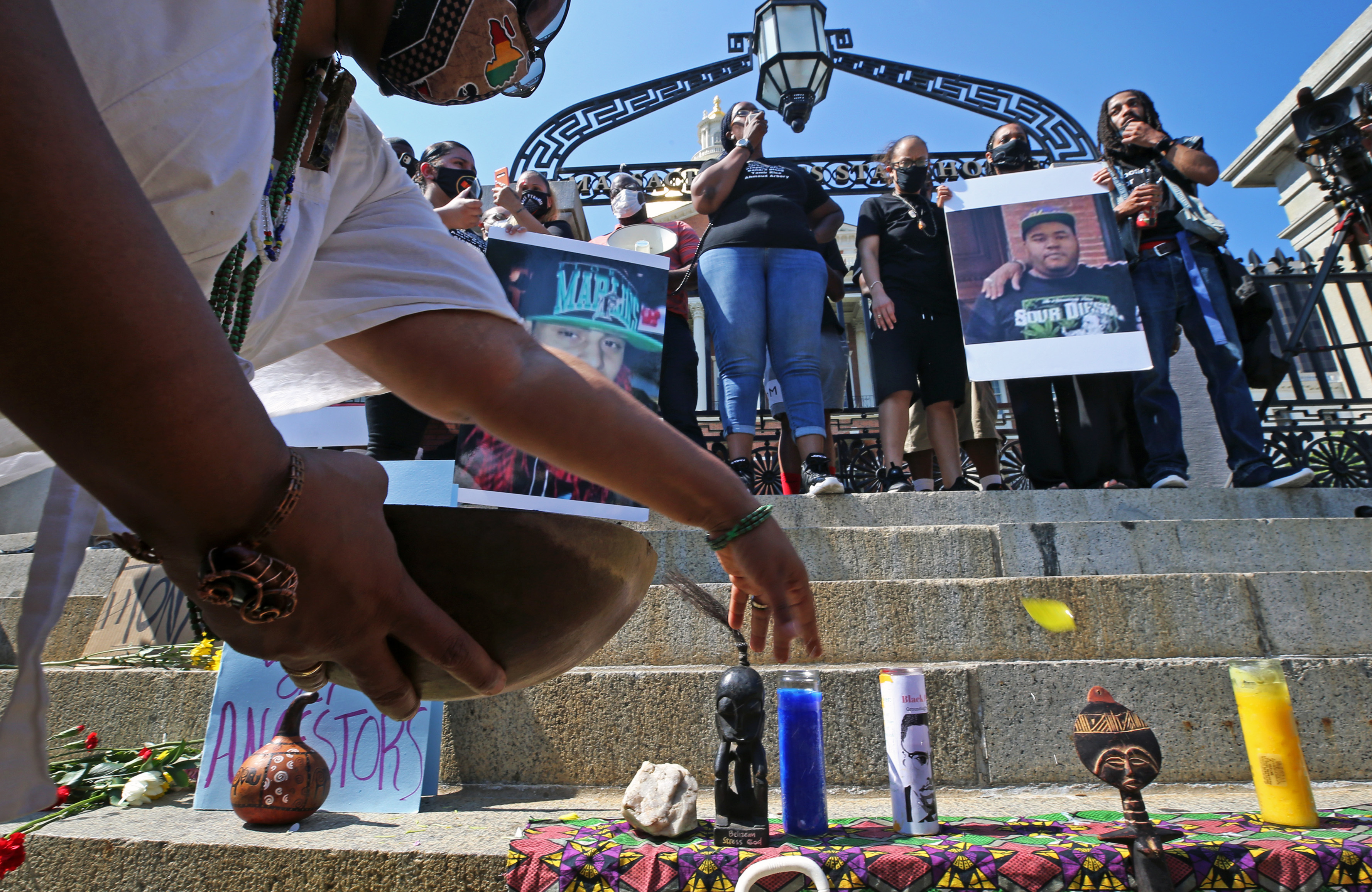 A woman tossed flower petals on to the steps of the State House as Monica Cannon-Grant addressed the crowd.