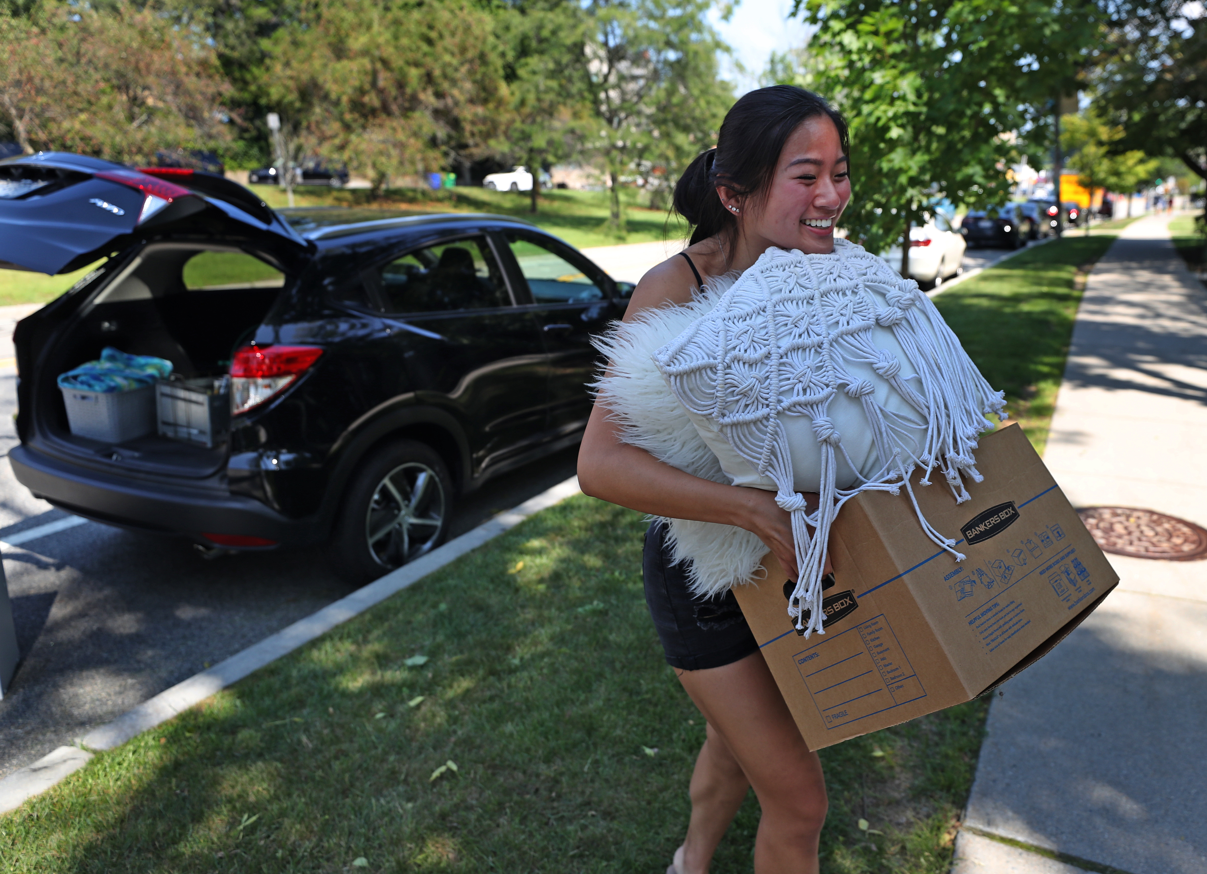 Boston College senior Ann Soong from NJ used her chin to keep control of her belongings as she moved into her dorm on the BC campus Thursday.
