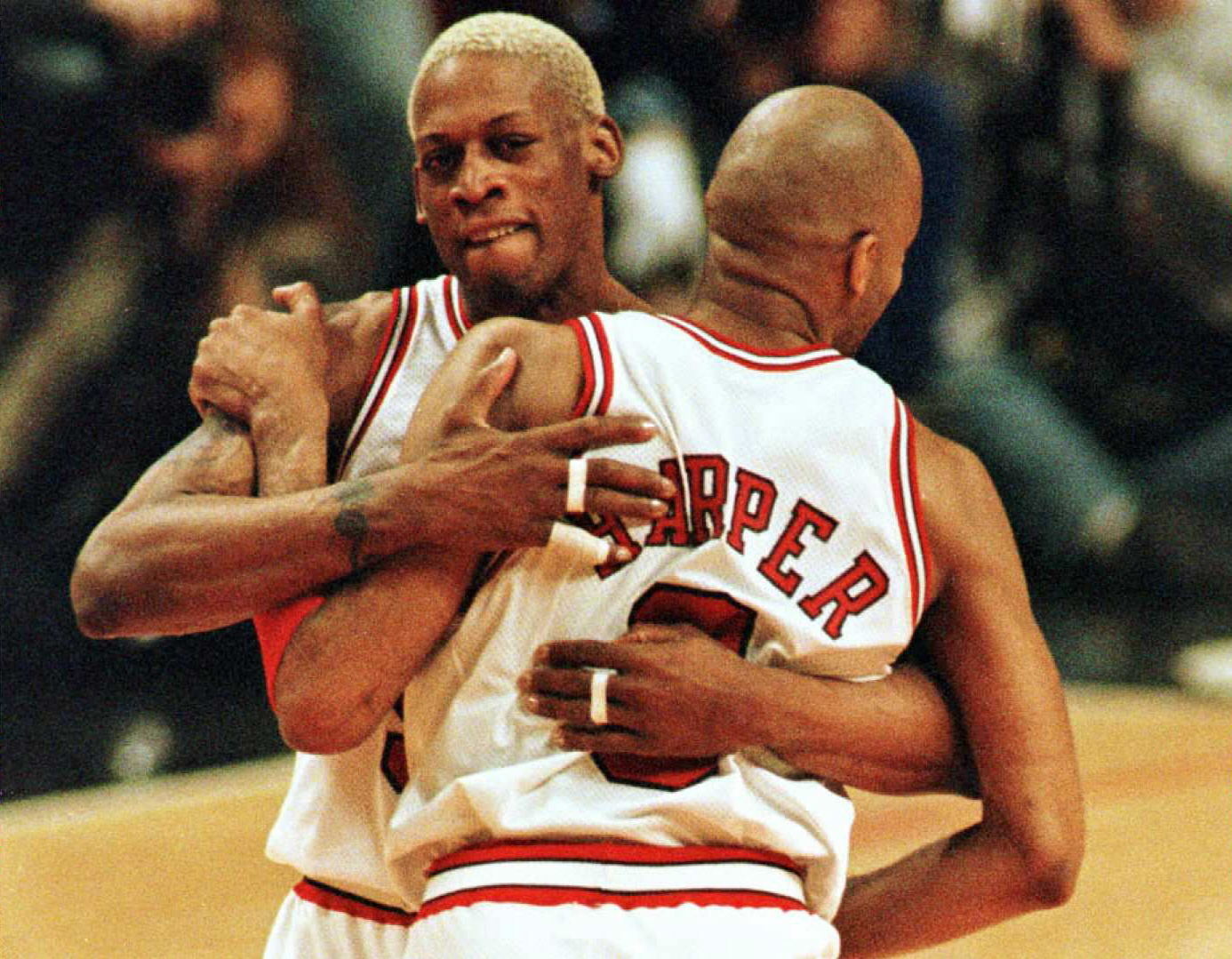 Chicago's Dennis Rodman and Ron Harper embrace after a playoff win over the Knicks.