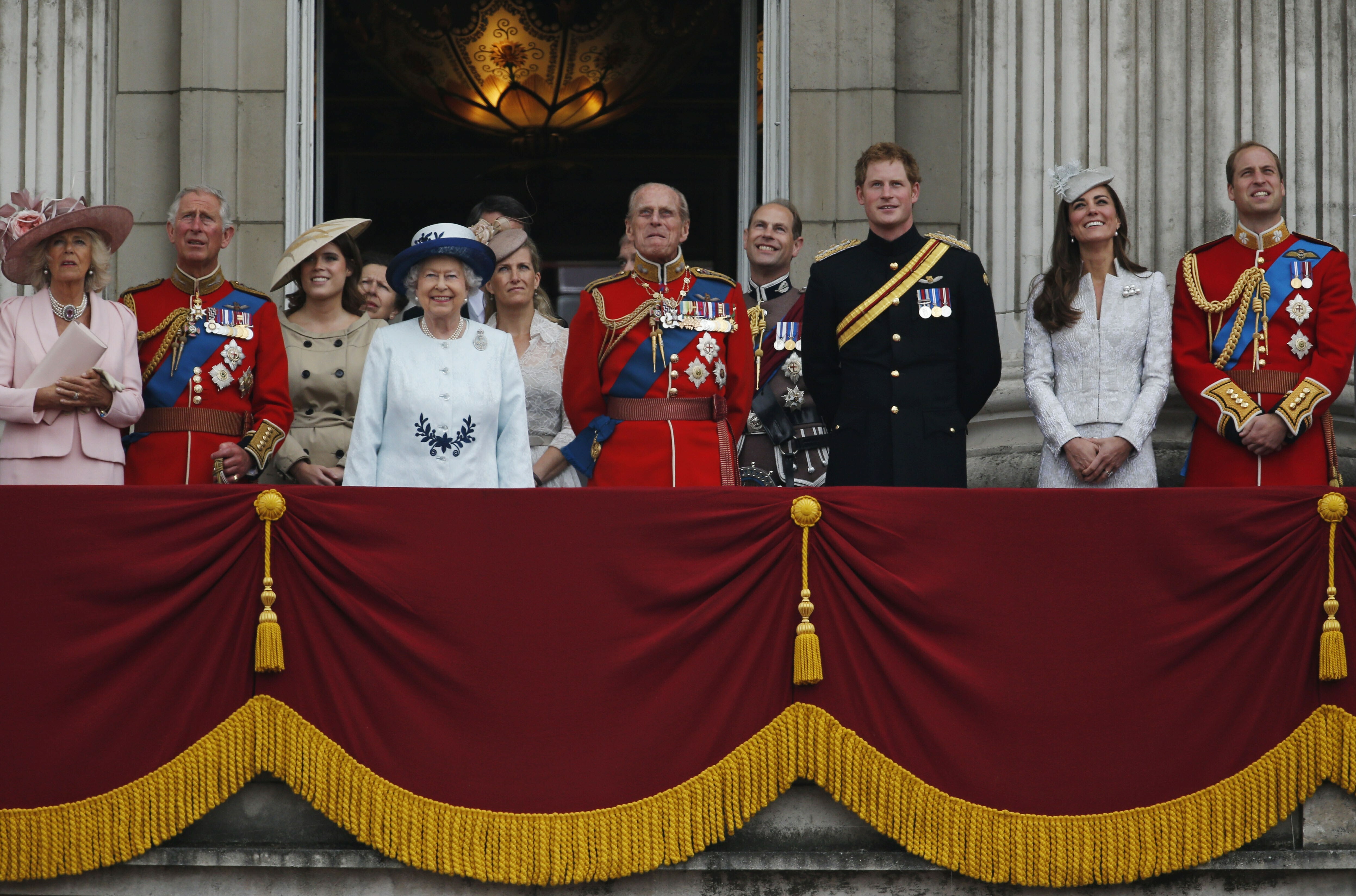 In this June 14, 2014 file photo, Britain's Queen Elizabeth II, accompanied by members of her family appear on the balcony of Buckingham Palace, during the Trooping The Colour parade, in central London. From left, Duchess of Cornwall, Prince Charles, Princess Eugenie, Sophie, the Duchess of Wessex, Prince Philip, Prince Edward, Prince Harry, Kate, Duchess of Cambridge and Prince William.