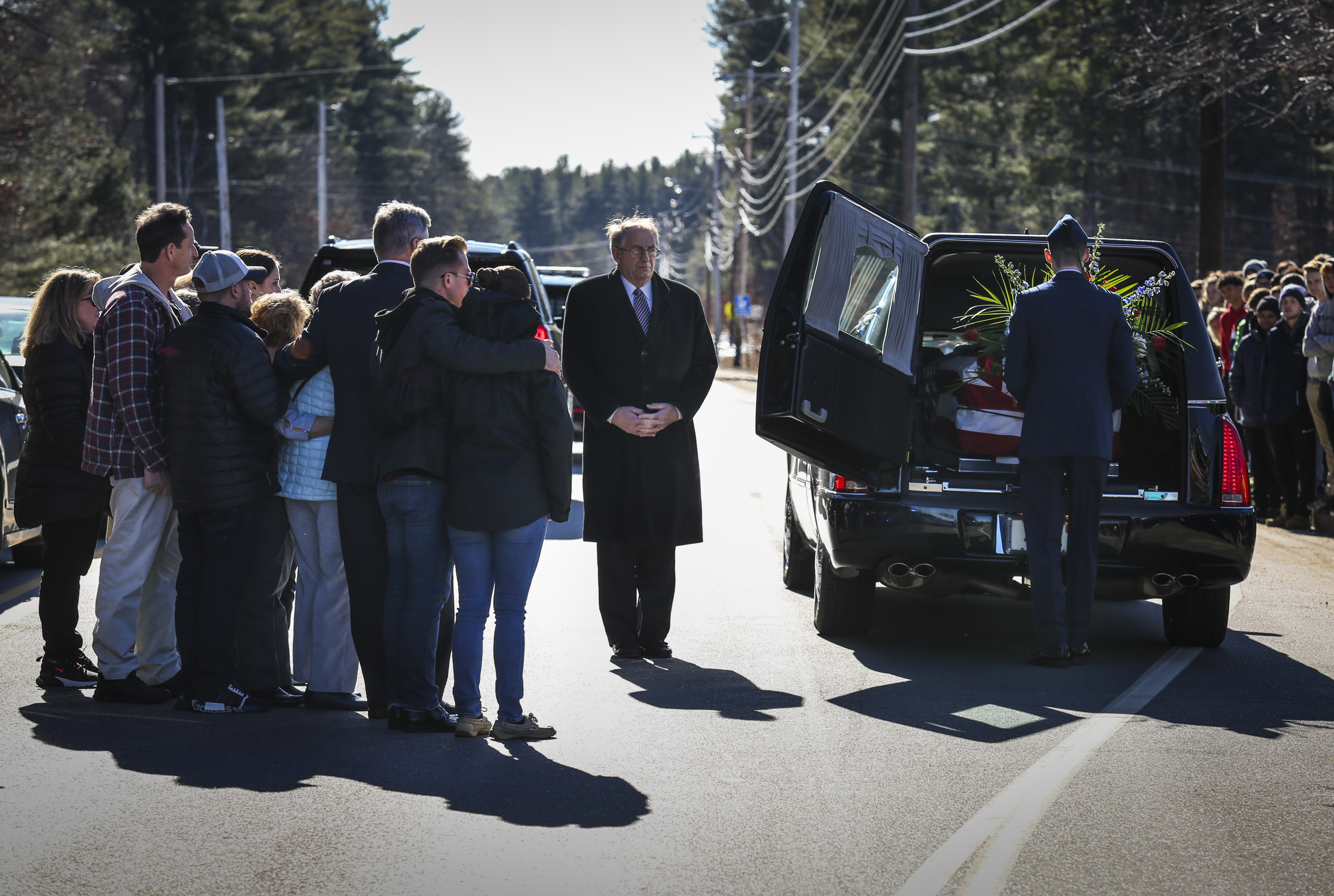 Family members held on to each other during a procession on January 30 for the casket of Katie Thyne, a Hudson, N.H., native who was killed while serving on the police force in Newport News, Va.