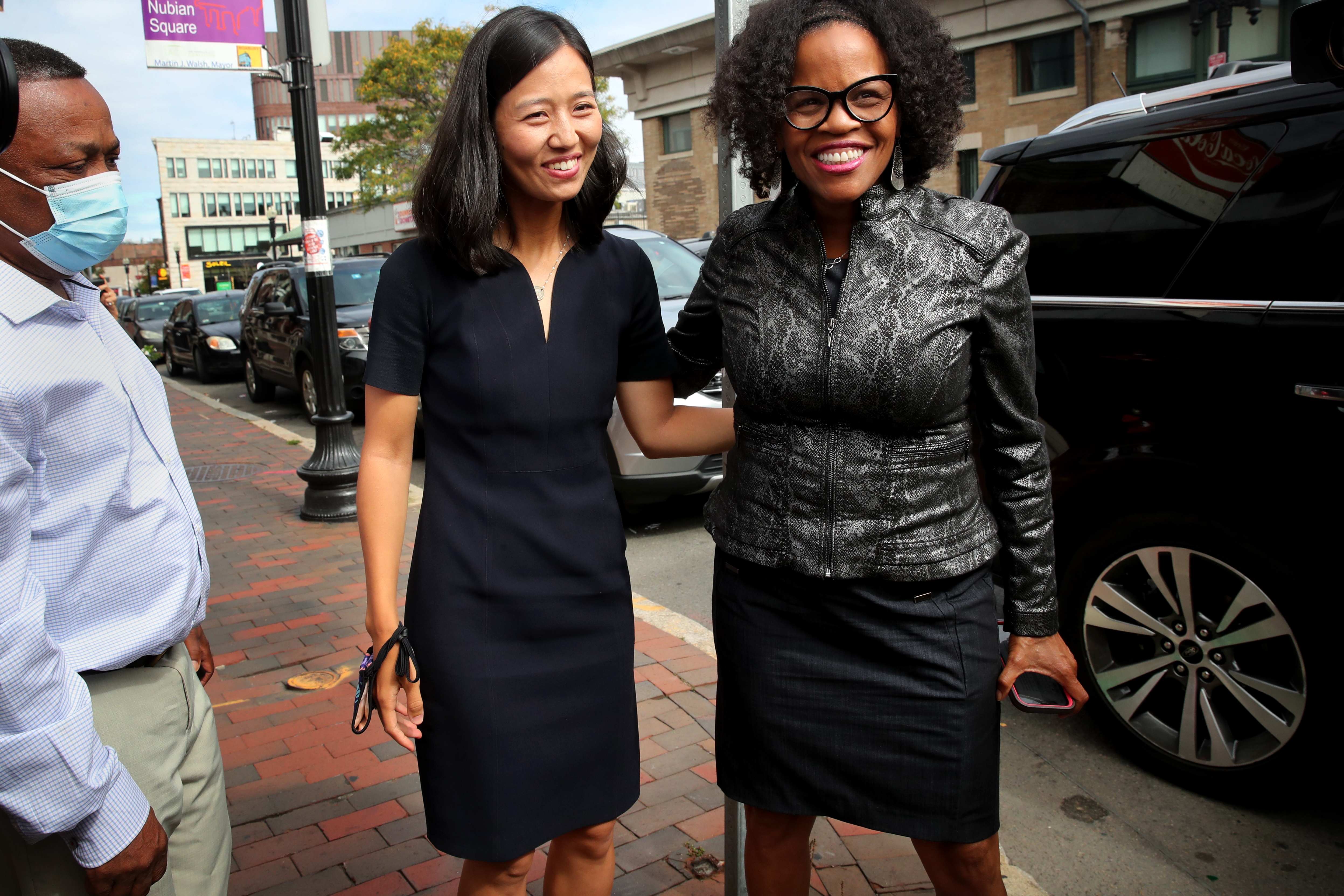 At-Large City Councilor and mayoral candidate Michelle Wu, center, and Acting Mayor Kim Janey arrive for the announcement in Roxbury.