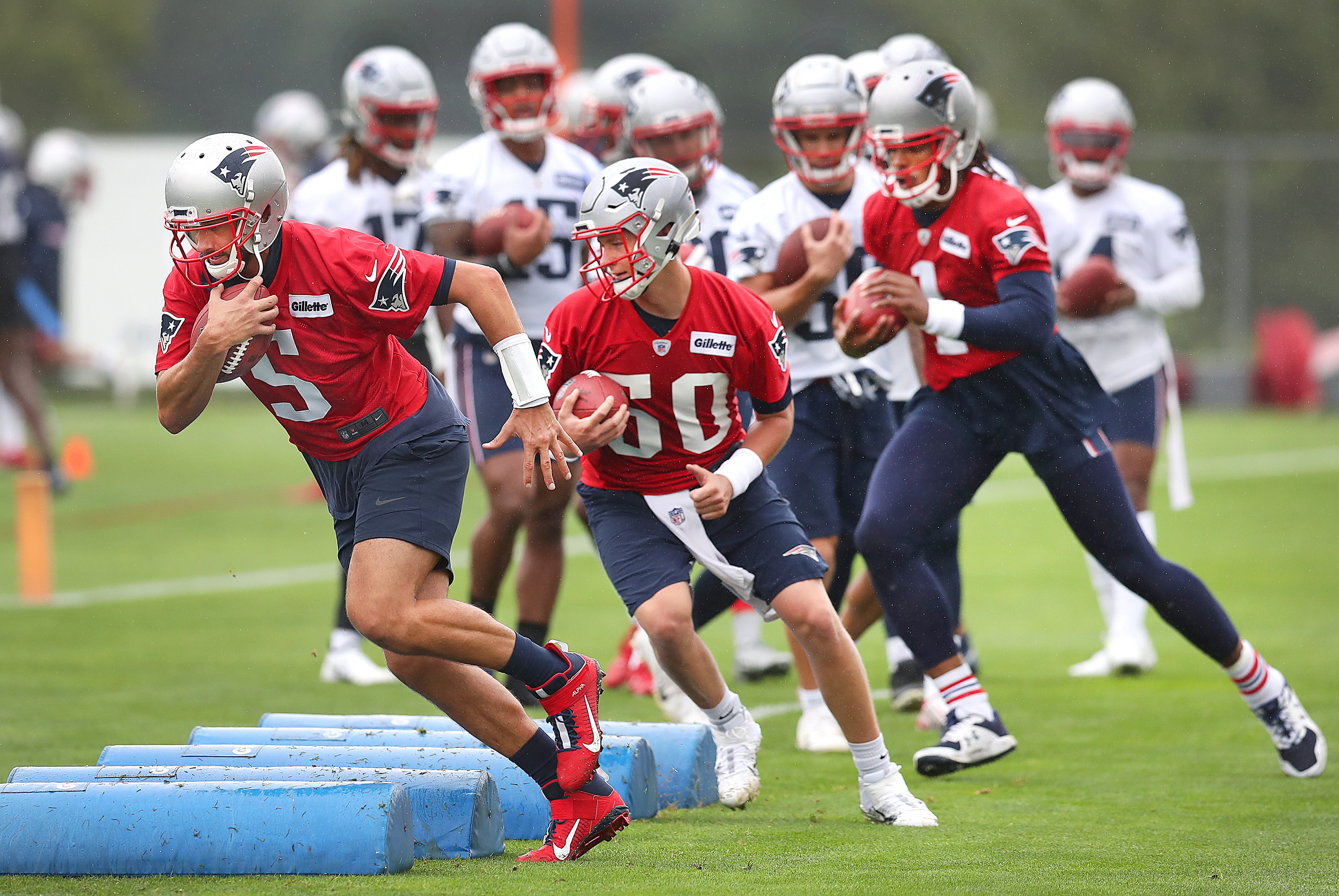 Quarterbacks (left to right) Brian Hoyer, Mac Jones and Cam Newton ran through an obstacle drill at the start of practice.