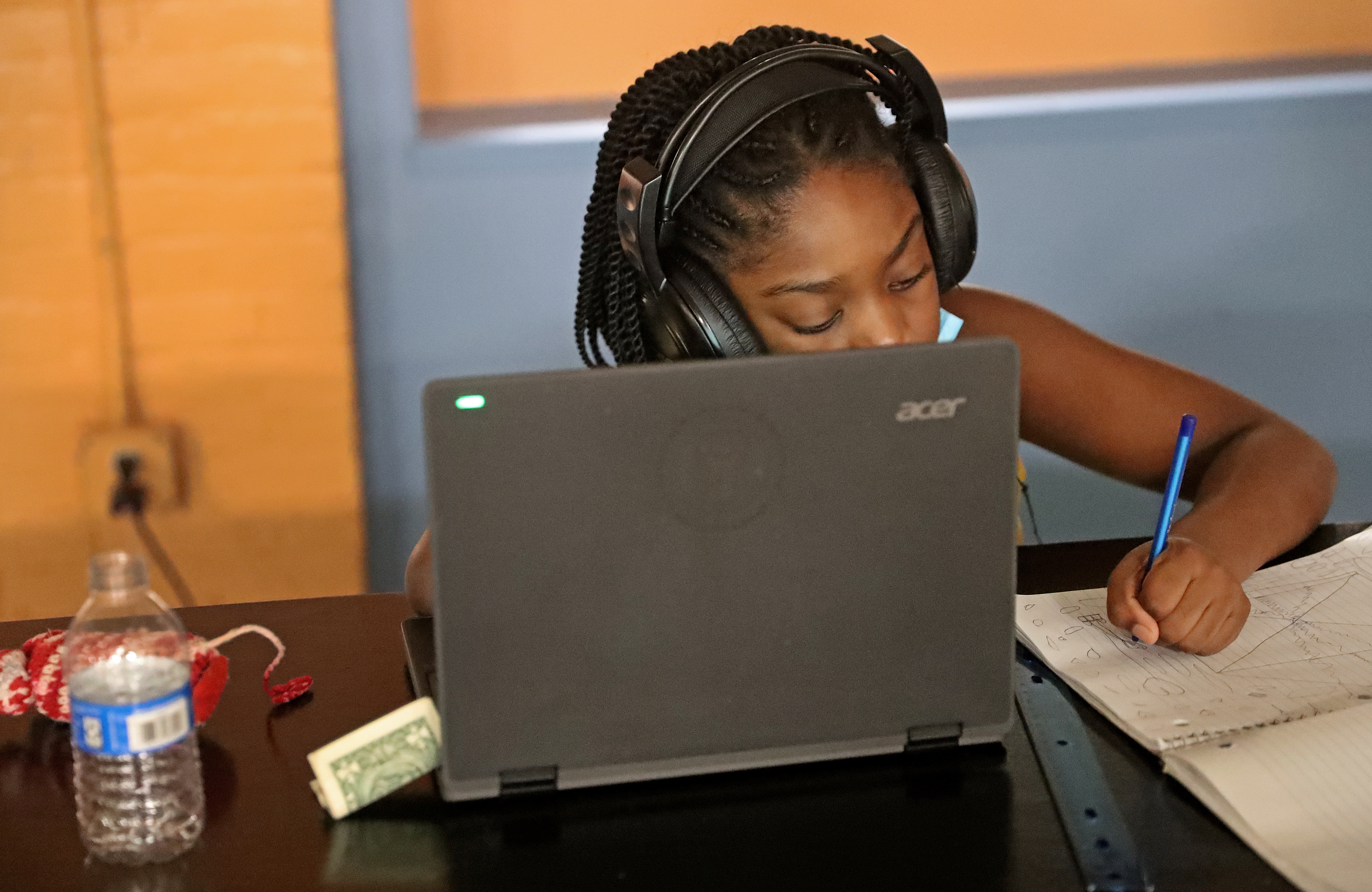 Abigail Saipnvil, 7, works on a laptop for her second-grade class. The Boys & Girls Club of Metro South in Brockton offers in-person programs for children during the COVID-19 pandemic, carefully following social distancing precautions.