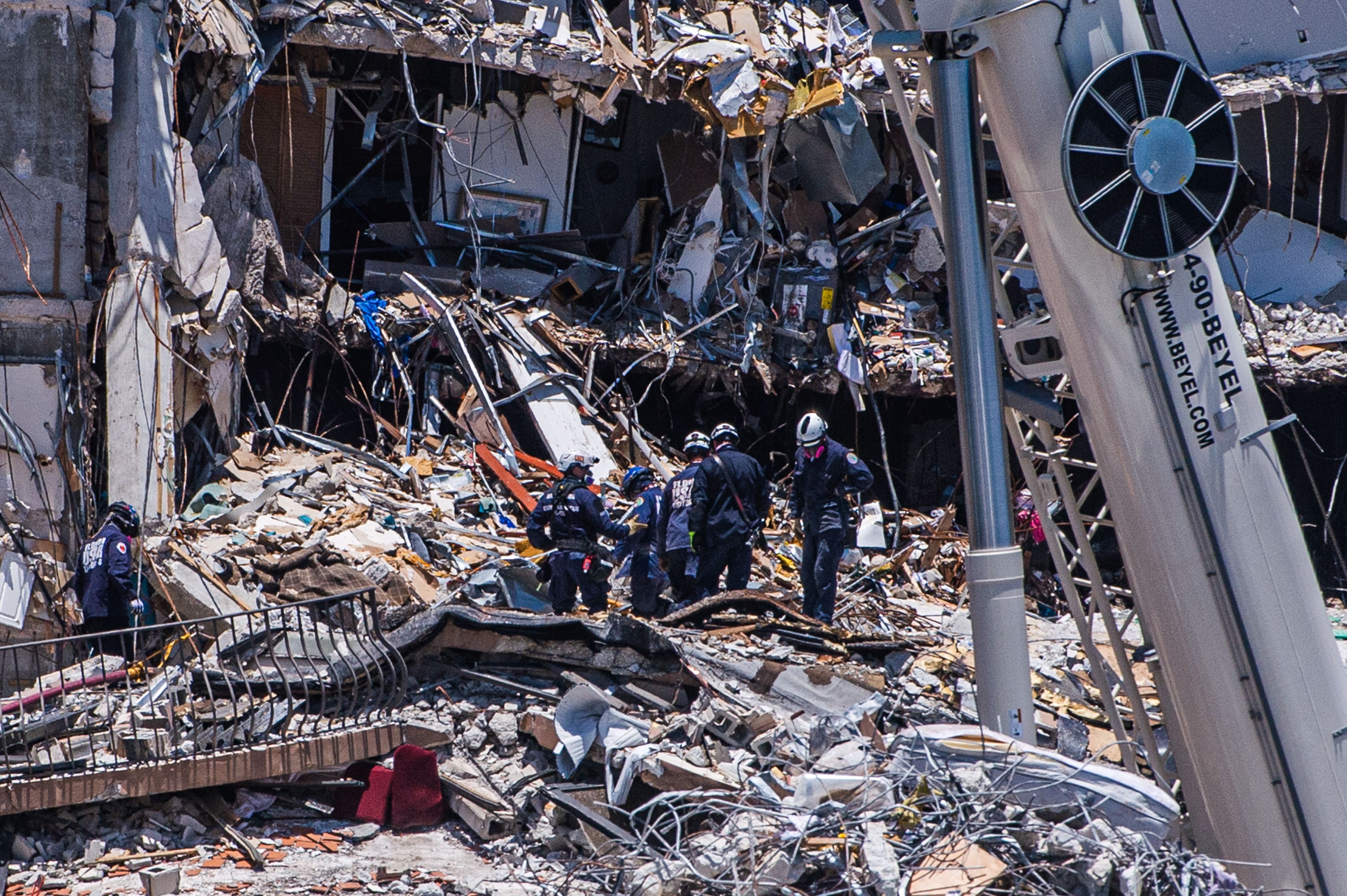 Search and Rescue teams look for possible survivors in the partially collapsed 12-story Champlain Towers South condo building on June 27, 2021 in Surfside, Florida.