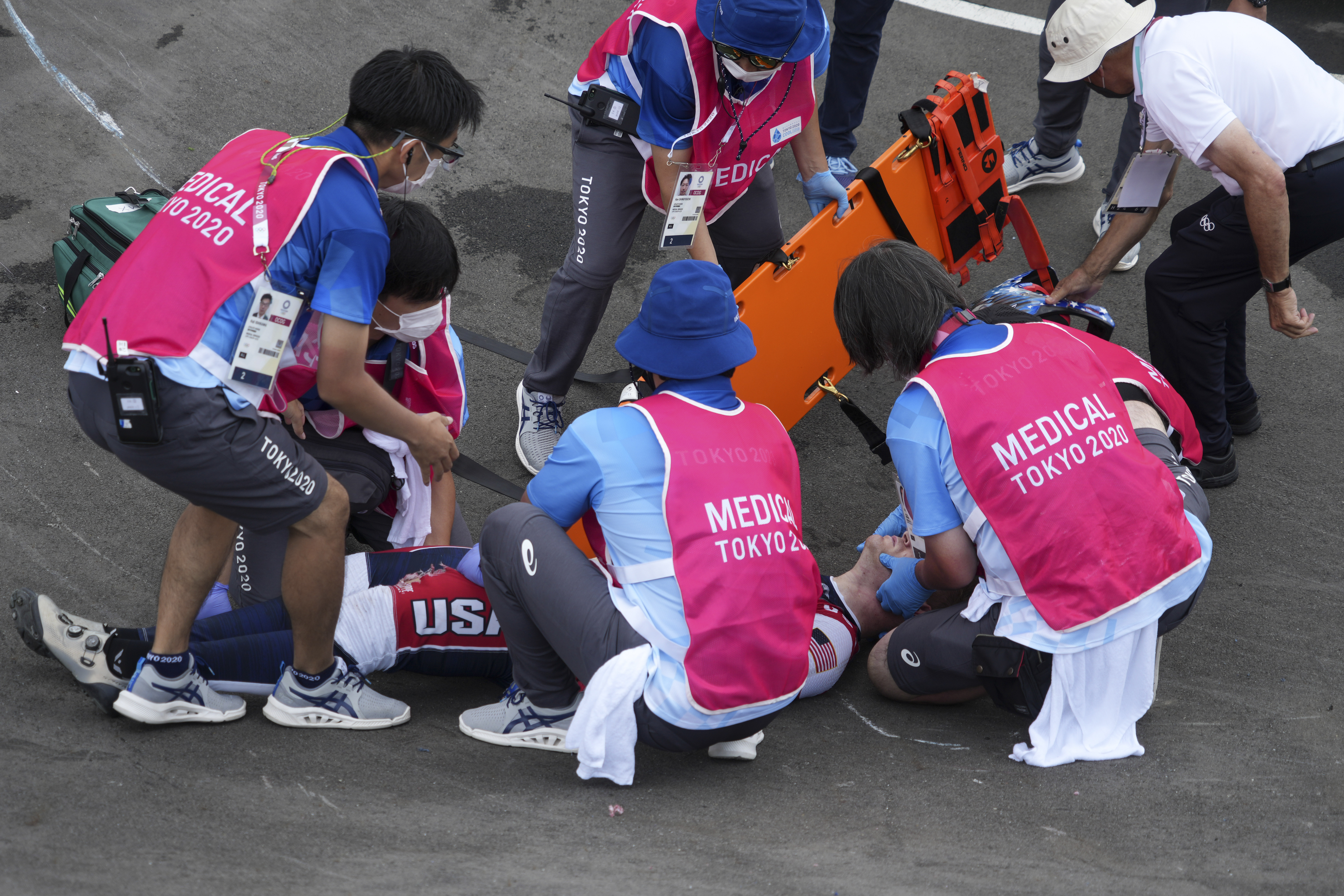 Connor Fields of the United States is treated on the track following a crash in a men's BMX semifinal heat.