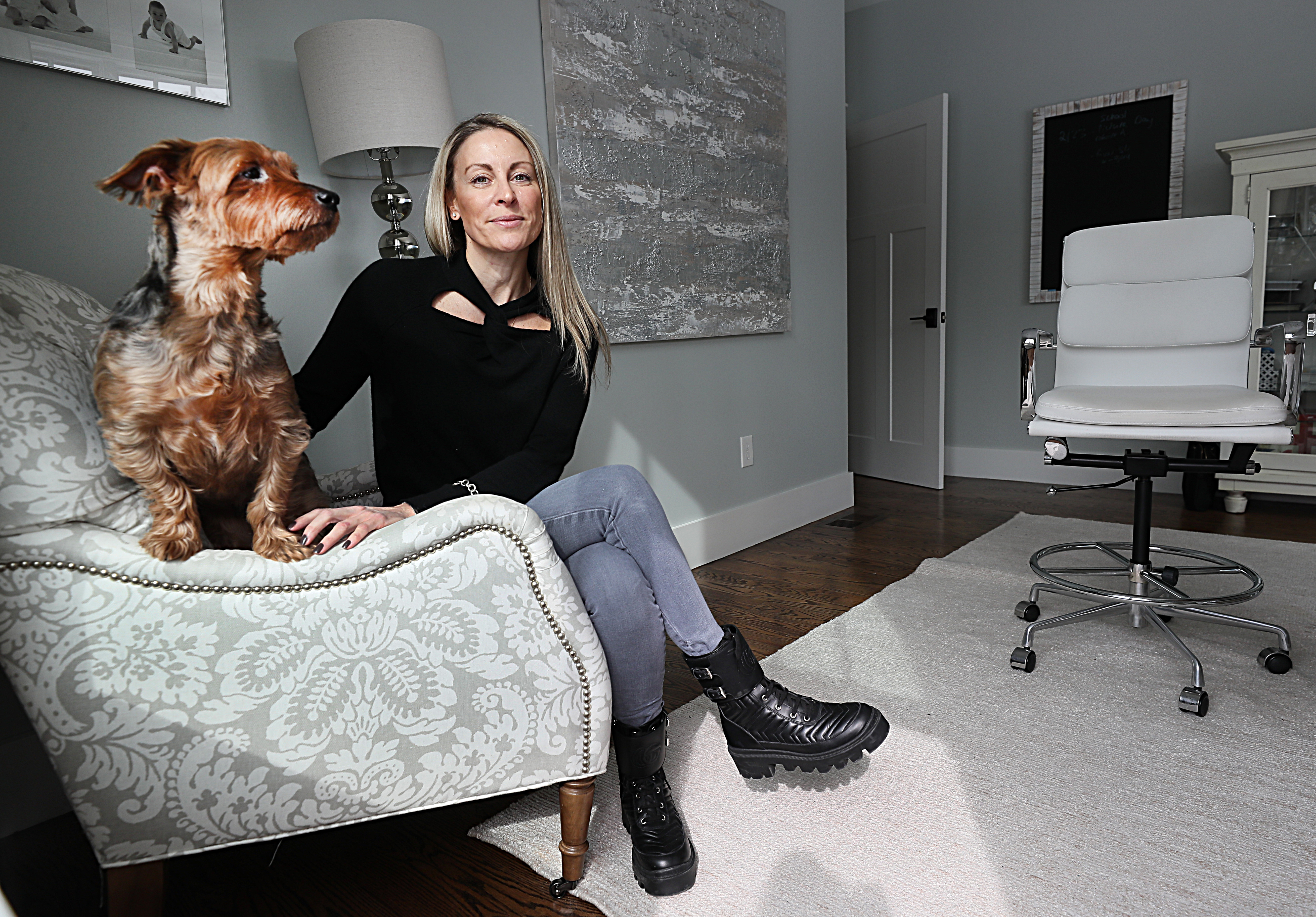 Jessica Weadock in her home office with her dog, Rocky.